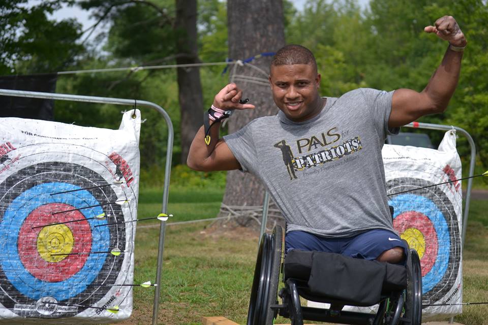 US Army Sgt. (ret.) Ryan Major enjoys archery at the Travis Mills Retreat in Rome, Maine.