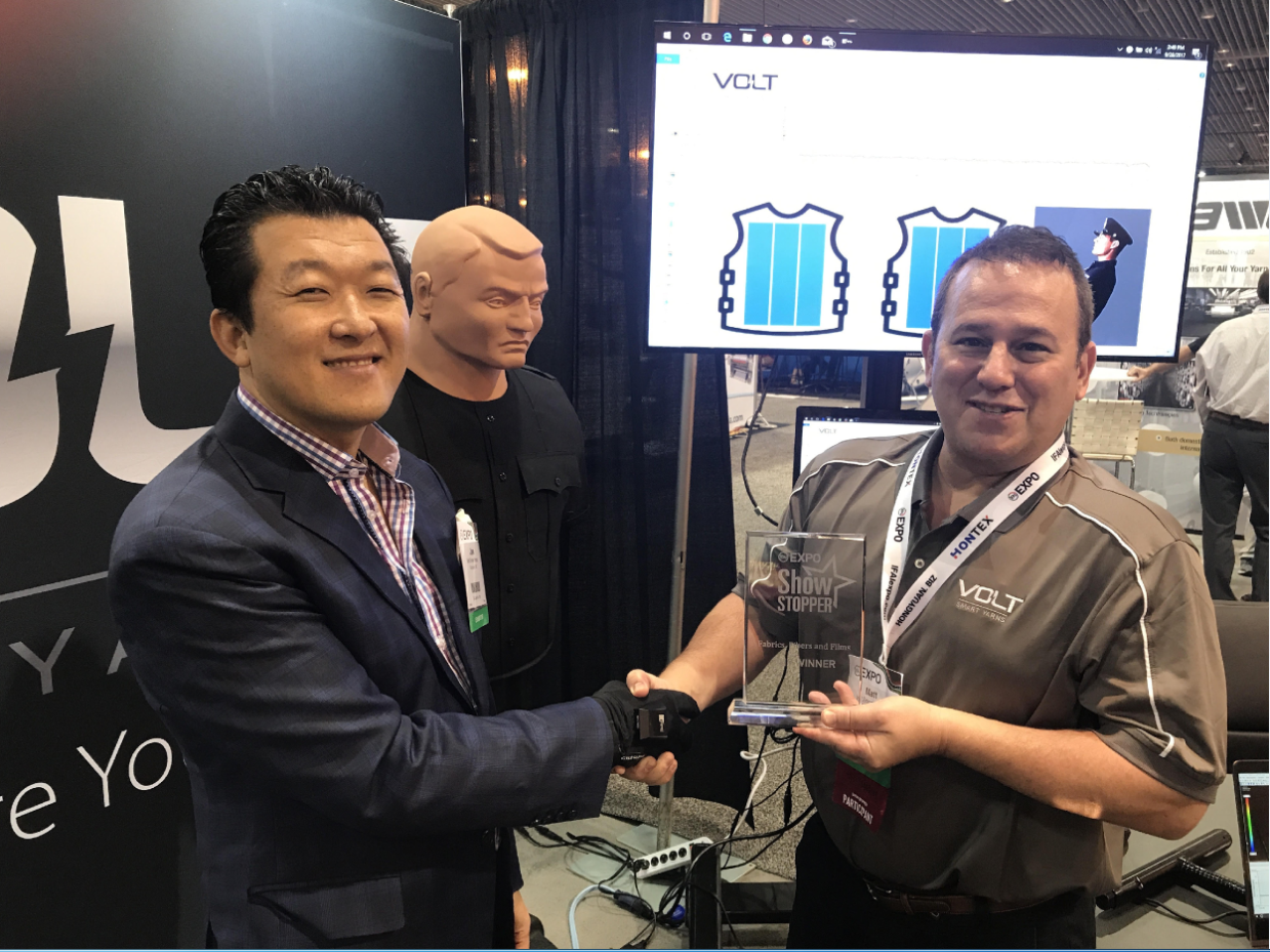 Dr. Jae Son, PPS Founder & CEO, and Matt Kolmes, Supreme Corporation CEO, shaking hands with the award