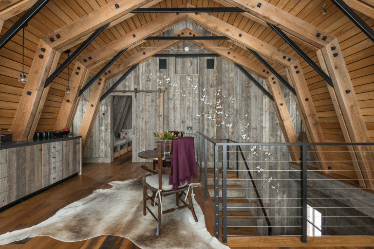 The guest barn featured in “Rustic Modern” with interiors by WRJ Design includes artwork such as this swarm of butterflies by Paul Villinski (photo by Audrey Hall).