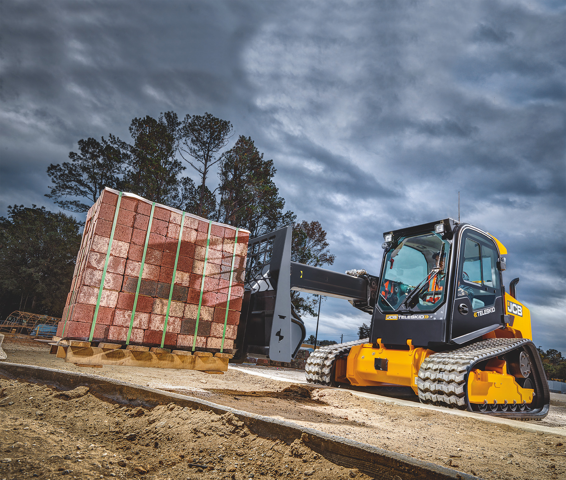The JCB Teleskid is the world’s only skid steer and compact track loader with a telescopic boom, allowing operators to lift above 13 feet, reach forward 8 feet and dig 3 feet below grade.