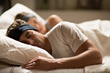 couple sleeping while wearing SleepPhones®.