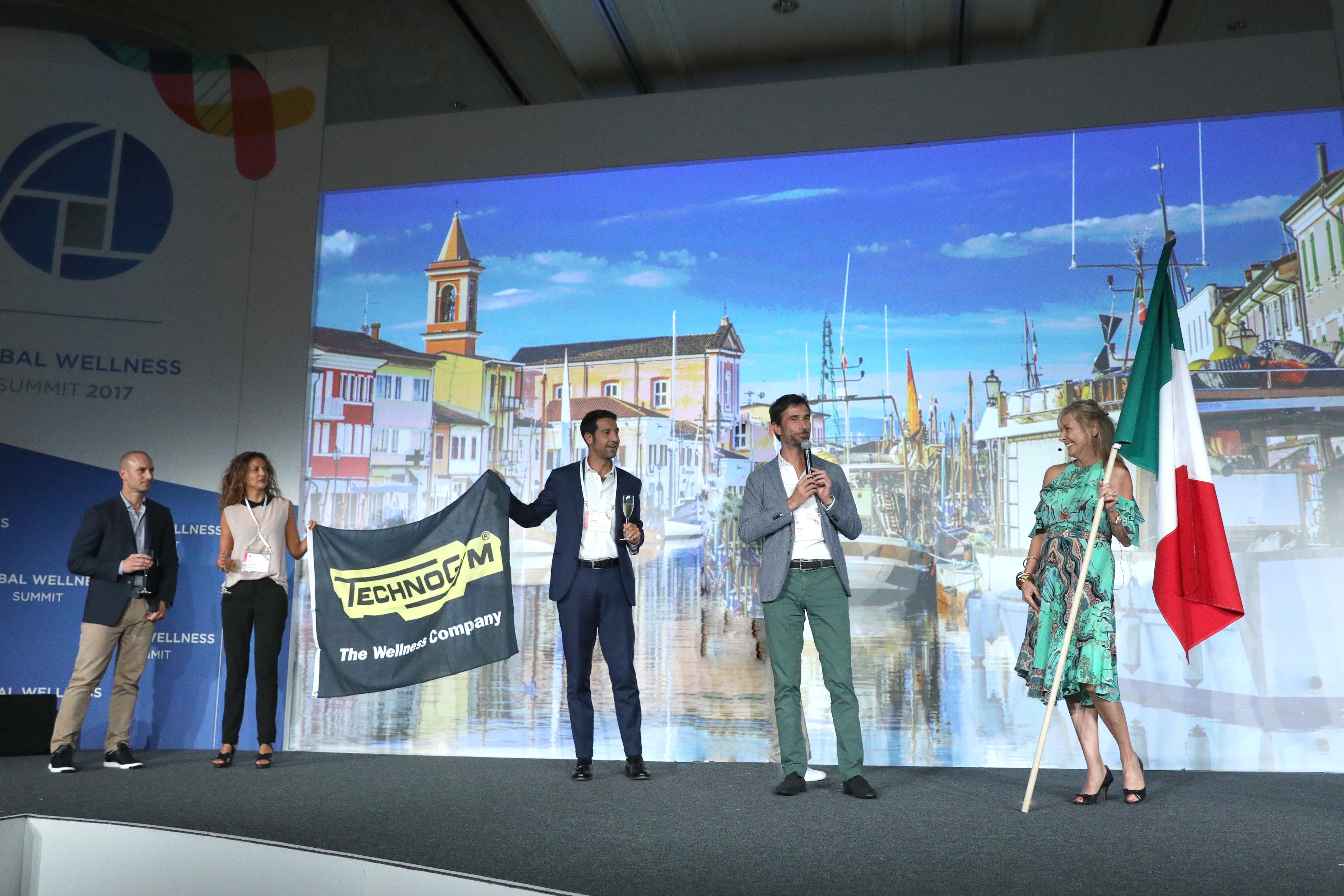 Susie Ellis (R), Chairman & CEO of the Global Wellness Summit, announces Technogym to host 2018 Summit at the Technogym Village in Cesena, Italy.