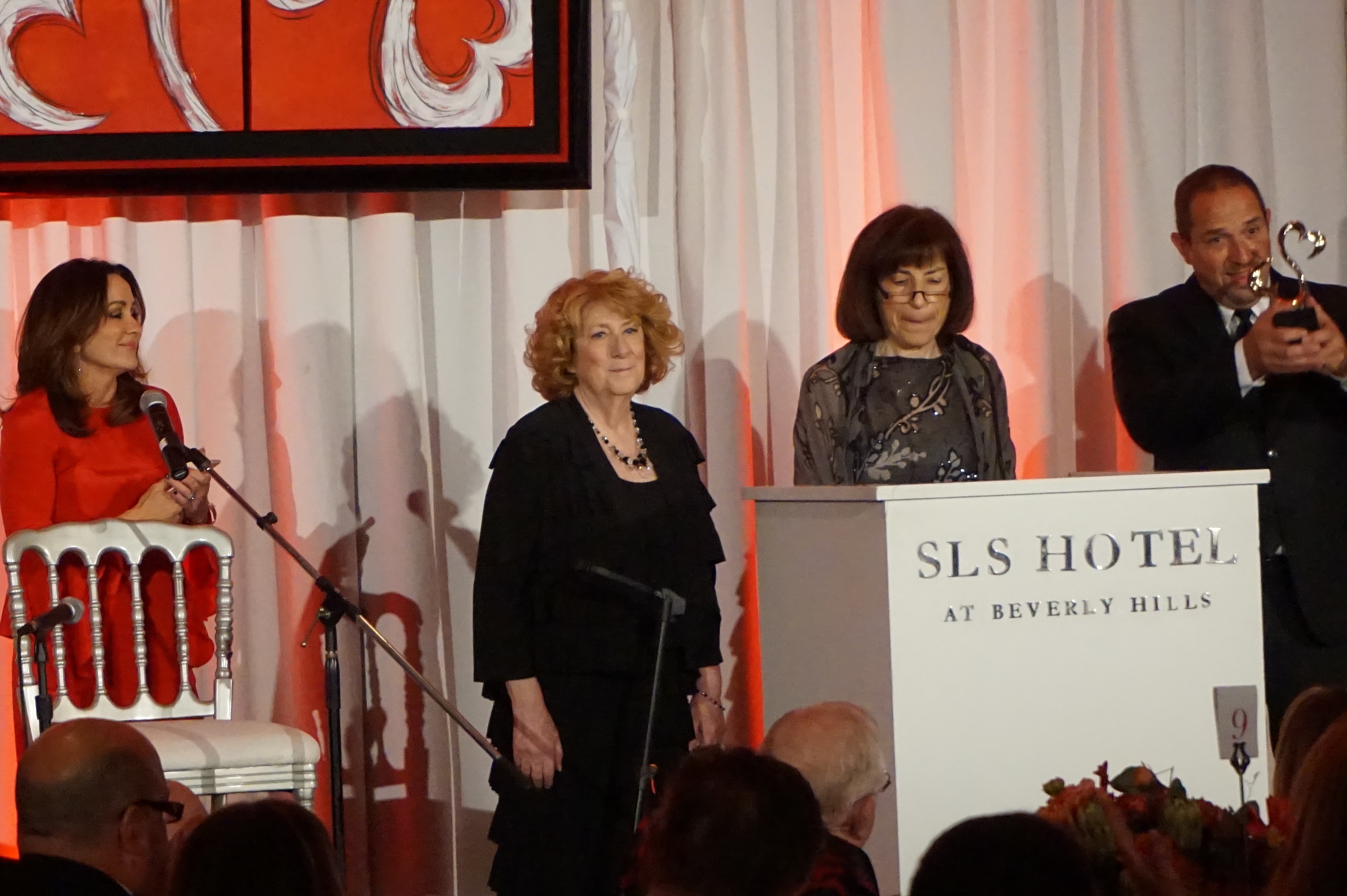 Patricia Heaton, left, presents Open Hearts award to Exceptional Minds co-founders Ernie Merlán, Yudi Bennett and Susan Zwerman.