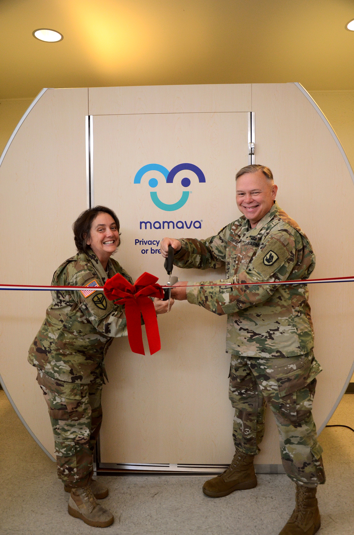 Command Sgt. Maj. Abby West (l) and Maj. Gen. Bret Daugherty, Adjutant General for the Washington Military Dept. welcome the first Mamava lactatioin suite to Washington National Guard's Camp Murray