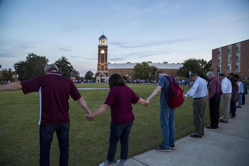 FHU President David R. Shannon and his wife, Tracie, join hands with students, board of trustee members and friends for prayer at the celebratory picnic after the inauguration Thursday, Oct. 19, 2017.