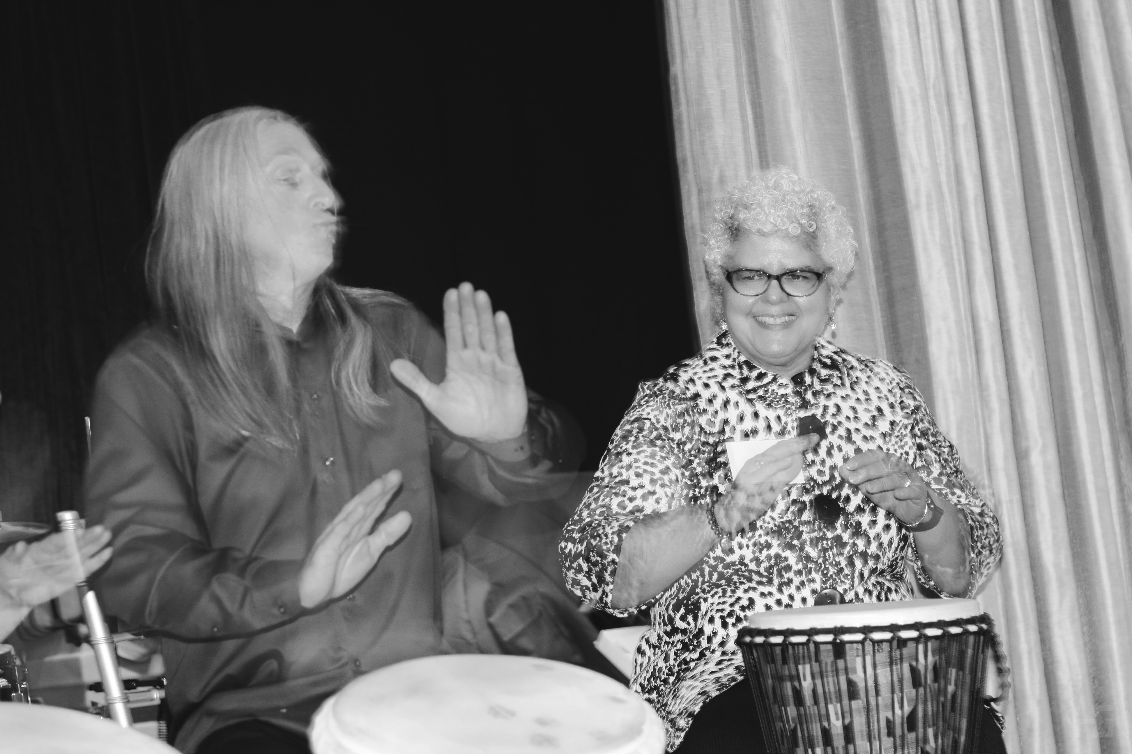 Nancy Gonzalez participating in Drumming Circle during recent Cancer Support Community Central NJ Fundraiser with instructor, Mark Wood