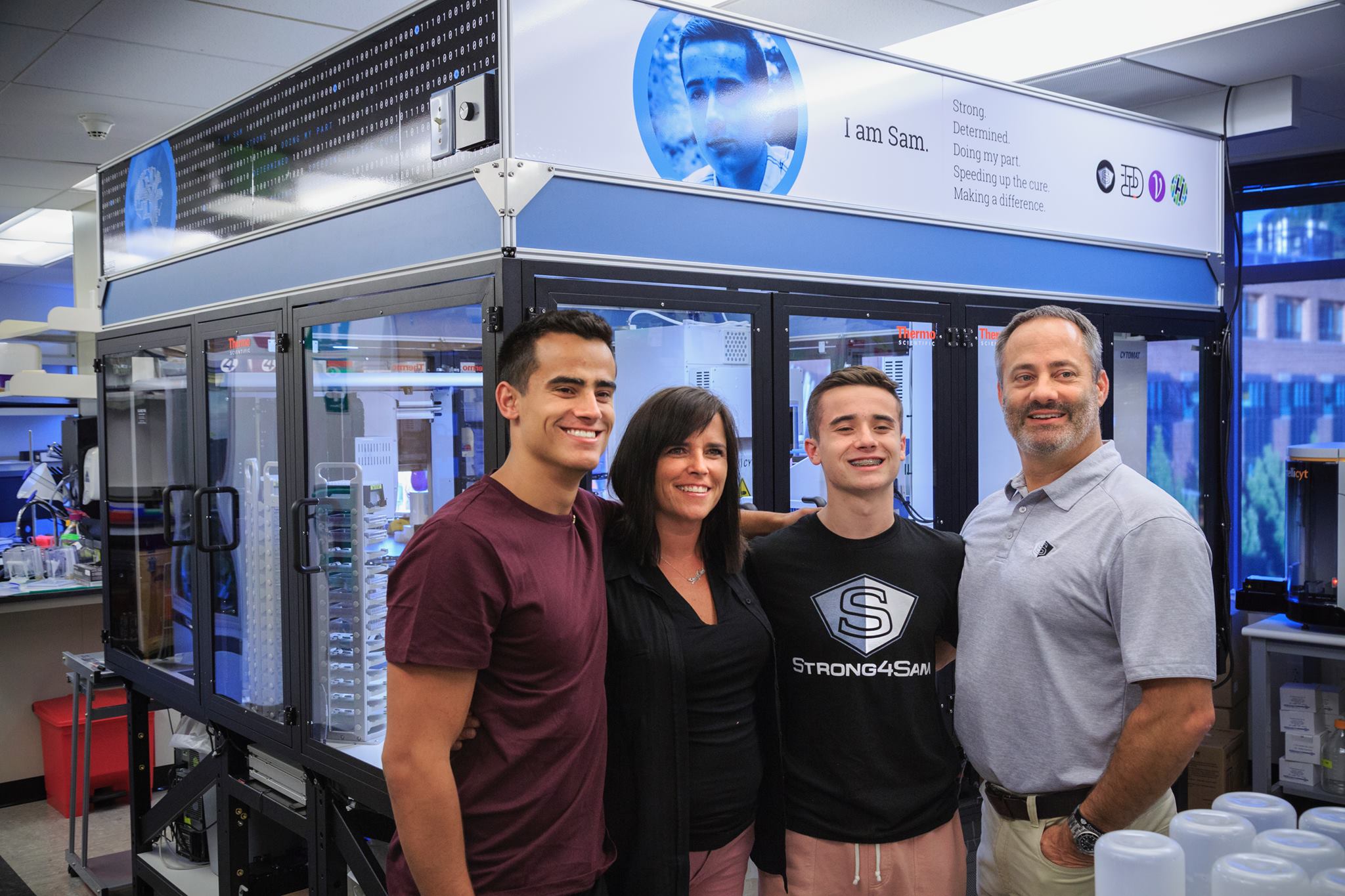 Alex Taylor, Kellea Taylor, Sam Taylor and Jeff Taylor (L-R) visit the Olson Lab at Fred Hutch