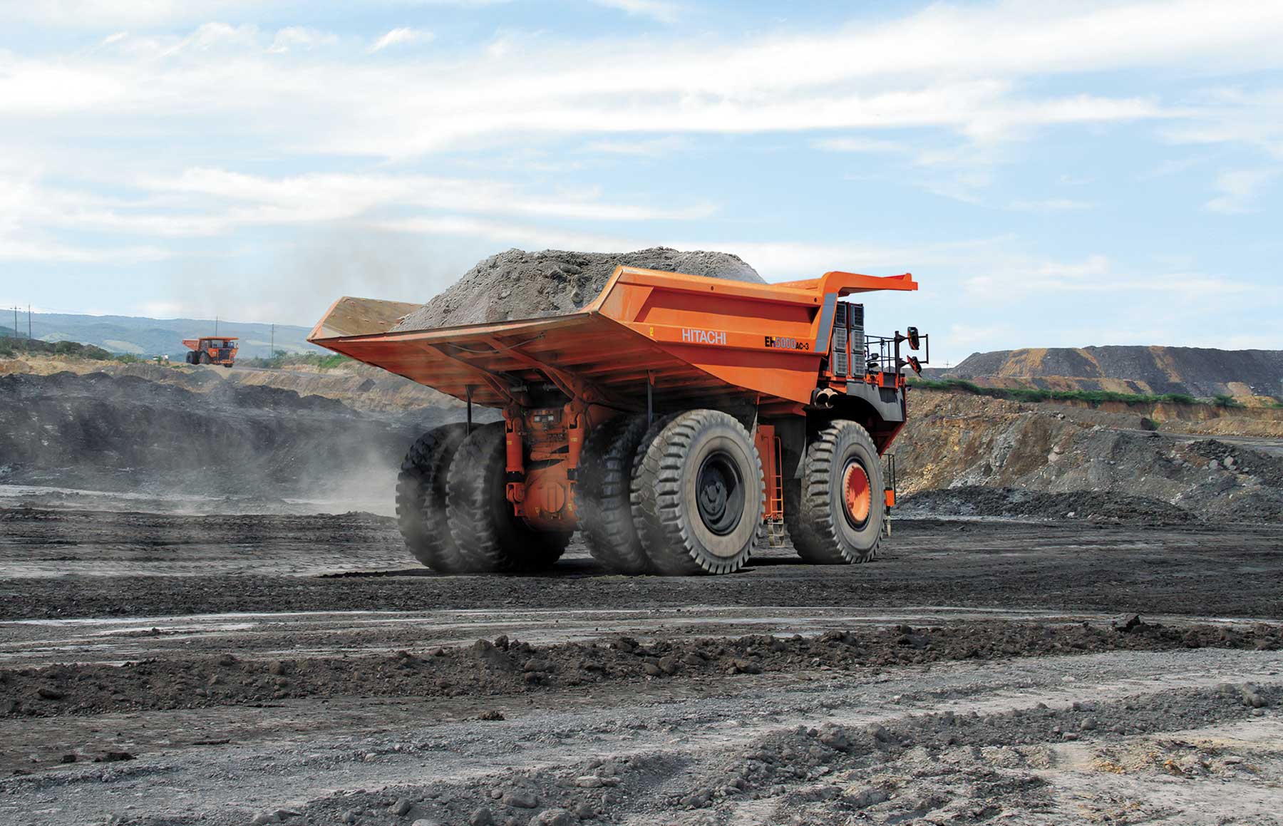 Hitachi trucks hauling at a mine site. Wenco and Hitachi Construction Machinery recently completed a successful trial of autonomous haul trucks at Stanwell Corporation's Meandu mine.