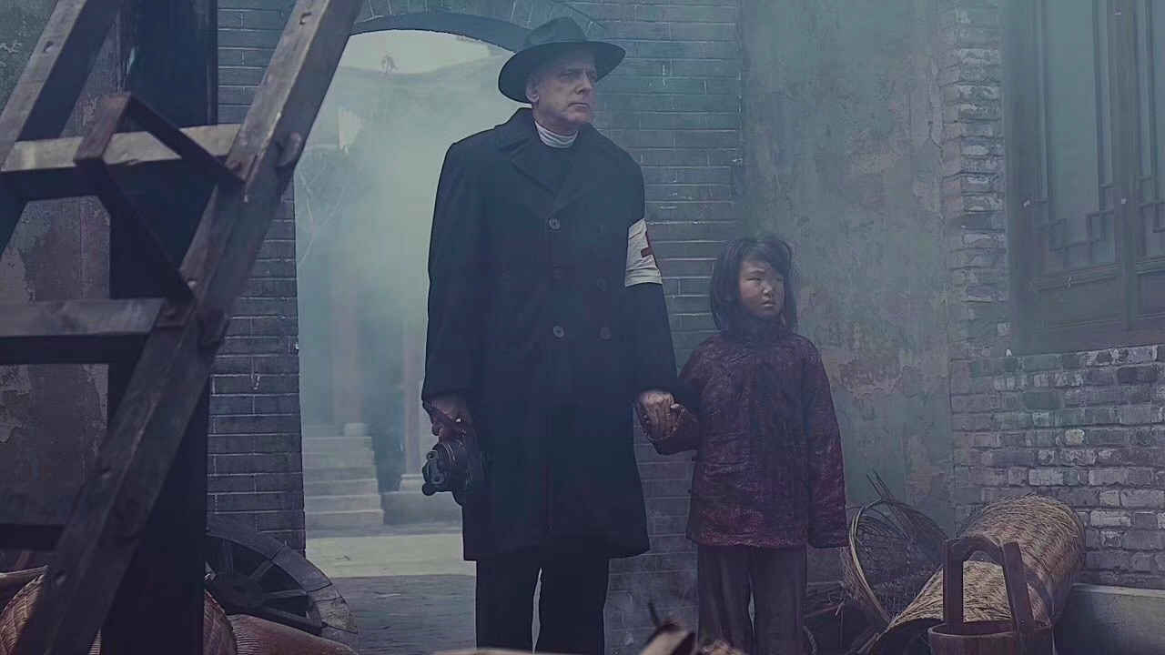 Father John Magee (Randall Lowell) about to film evidence of an atrocity in SCARS OF NANKING.