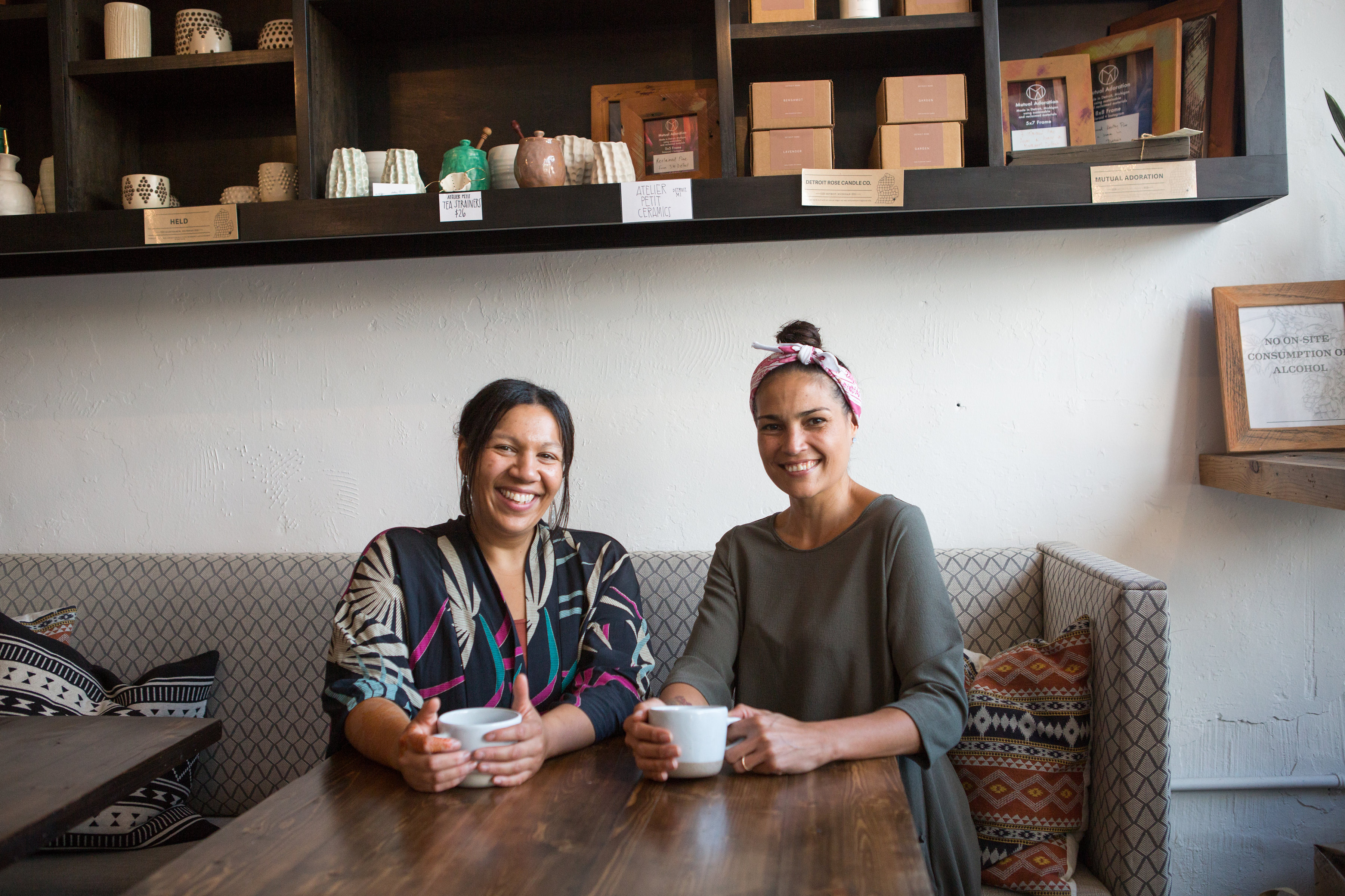Co-owners Kiki Louya and Rohani Foulkes enjoy a moment of quiet at The Farmer's Hand artisanal cafe and market, located in the historic Corktown district of Detroit.