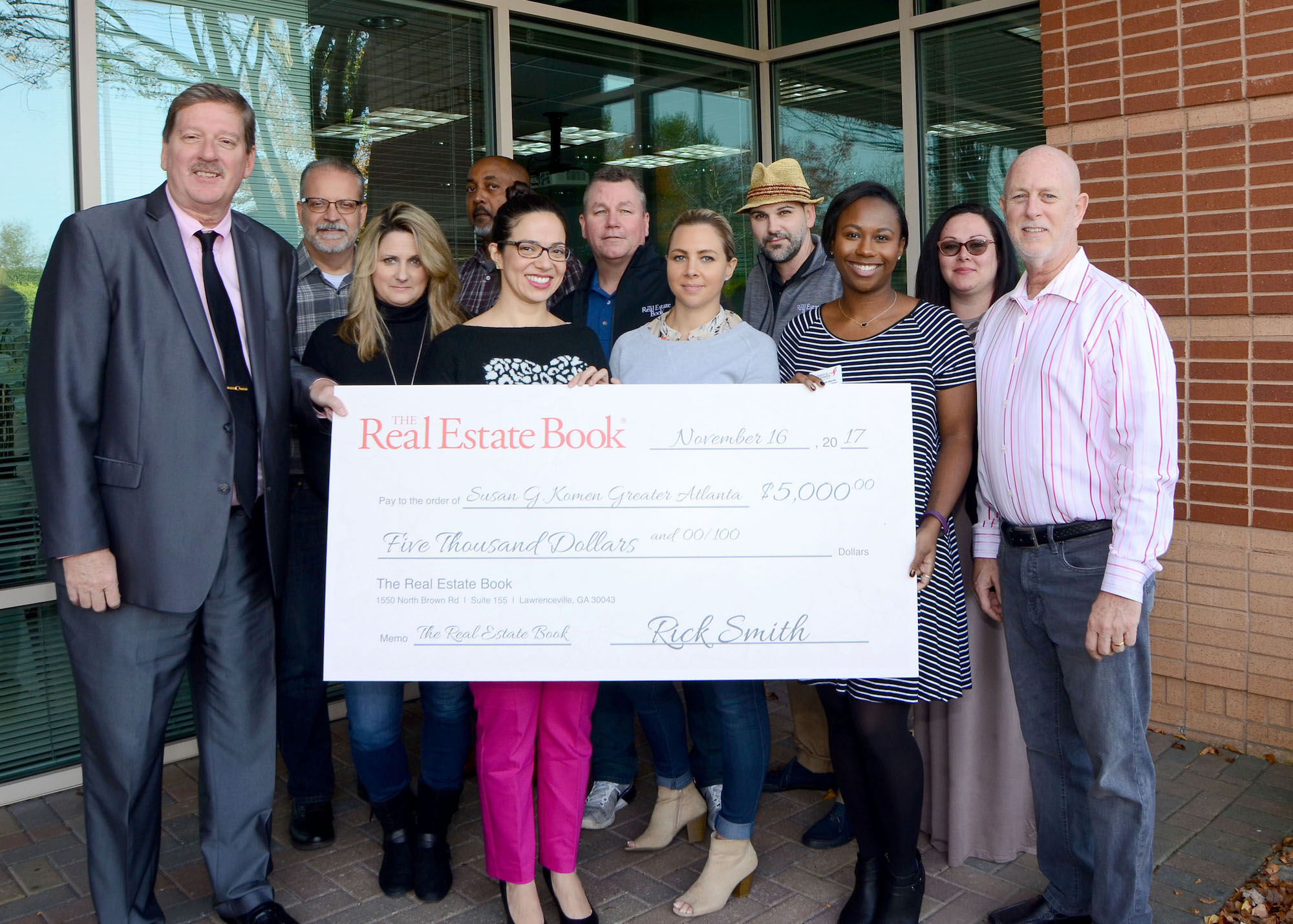 The Real Estate Book Senior Vice President and Brand Leader Rick Smith (left) and team donate check to Susan G. Komen Greater Atlanta
