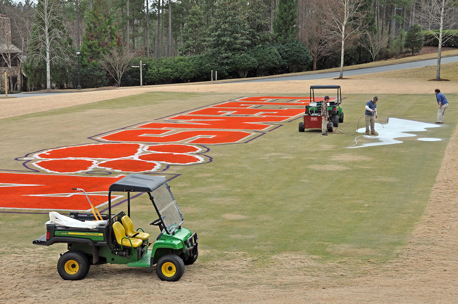 Golf Maintenance crew painting the end zone