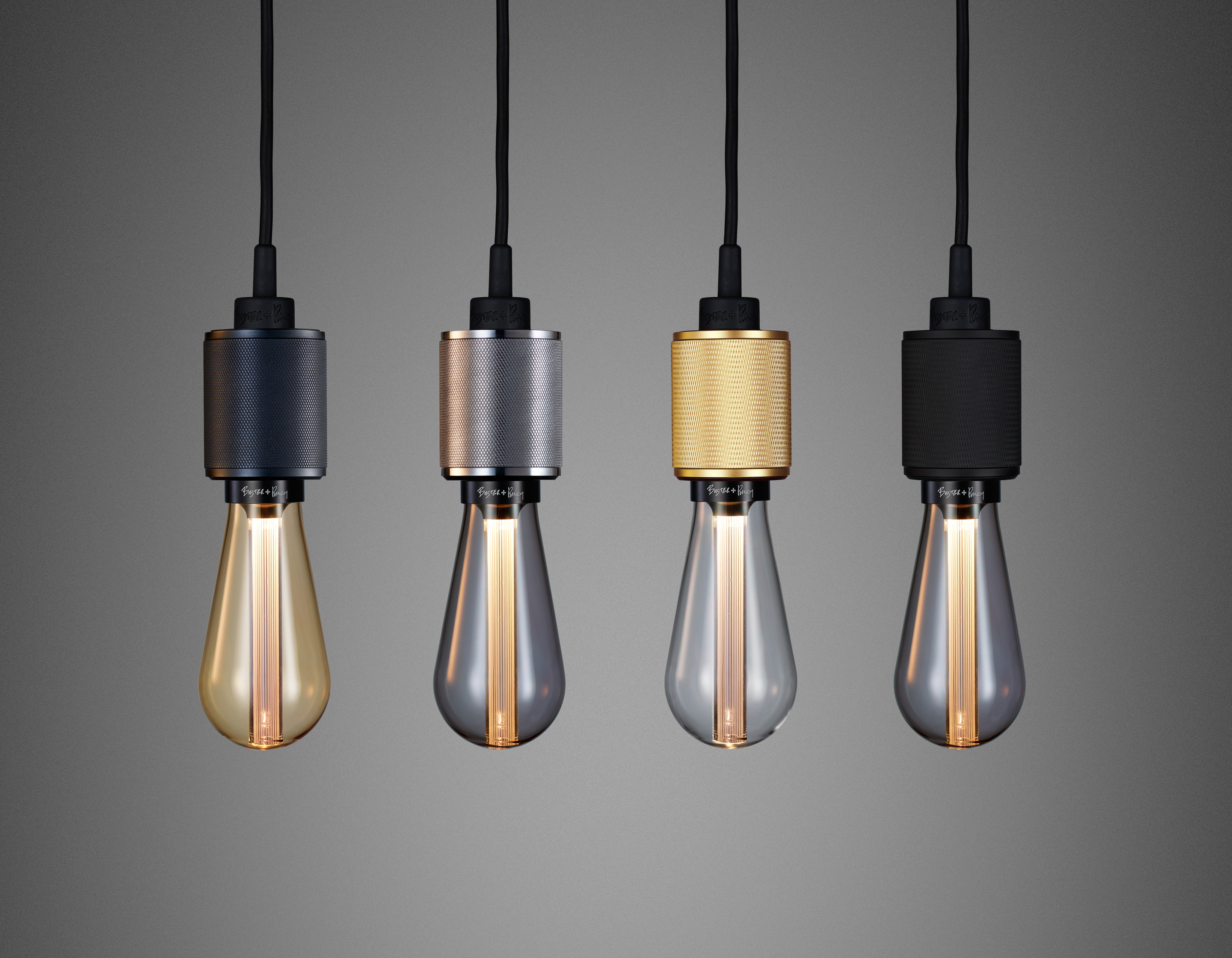 Buster + Punch's Heavy Metal pendants showcase the award winning BUSTER Bulb. (shown in smoked bronze, steel, brass and matte black)