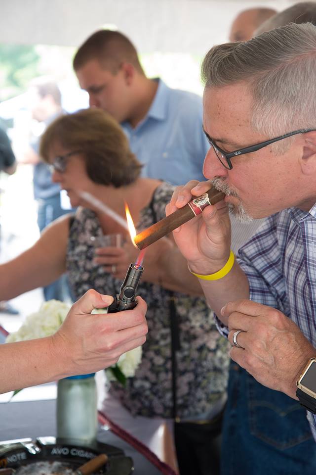 Customers lighting up cigars at public mixer