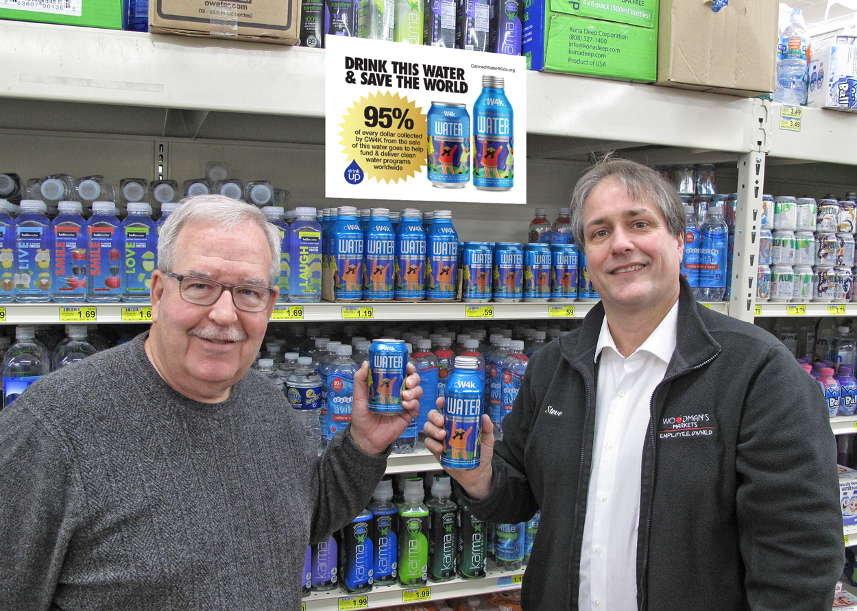 Greg Stromberg, CW4K Founder & CEO (left) and Steve Affeldt, Water Category Manager at Woodman's Markets with CW4K drinking water in-store.