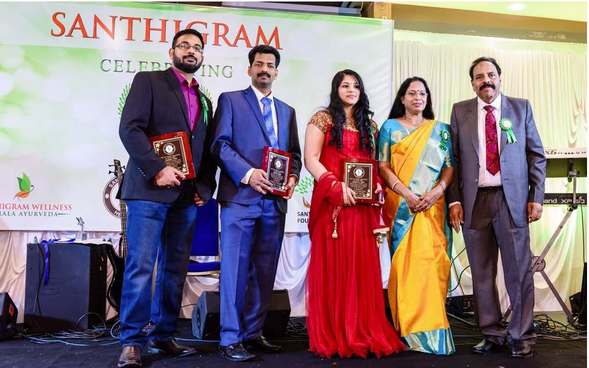 santhigram founders honoring with excellence awards to its employees Nishad, Meenu and Pradeep who have completed 5 years of dedicated service with Santhigram USA