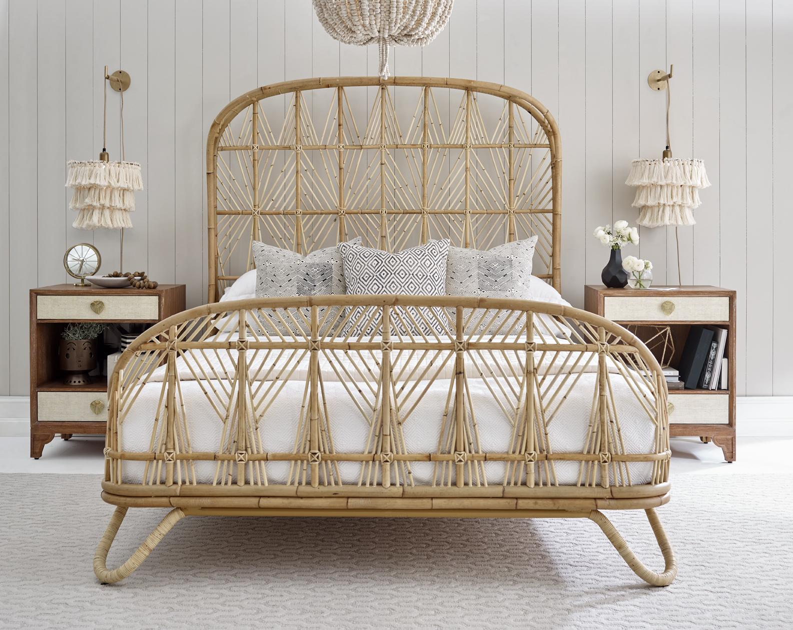 The Ara Bed features woven rattan detailing and a natural finish.