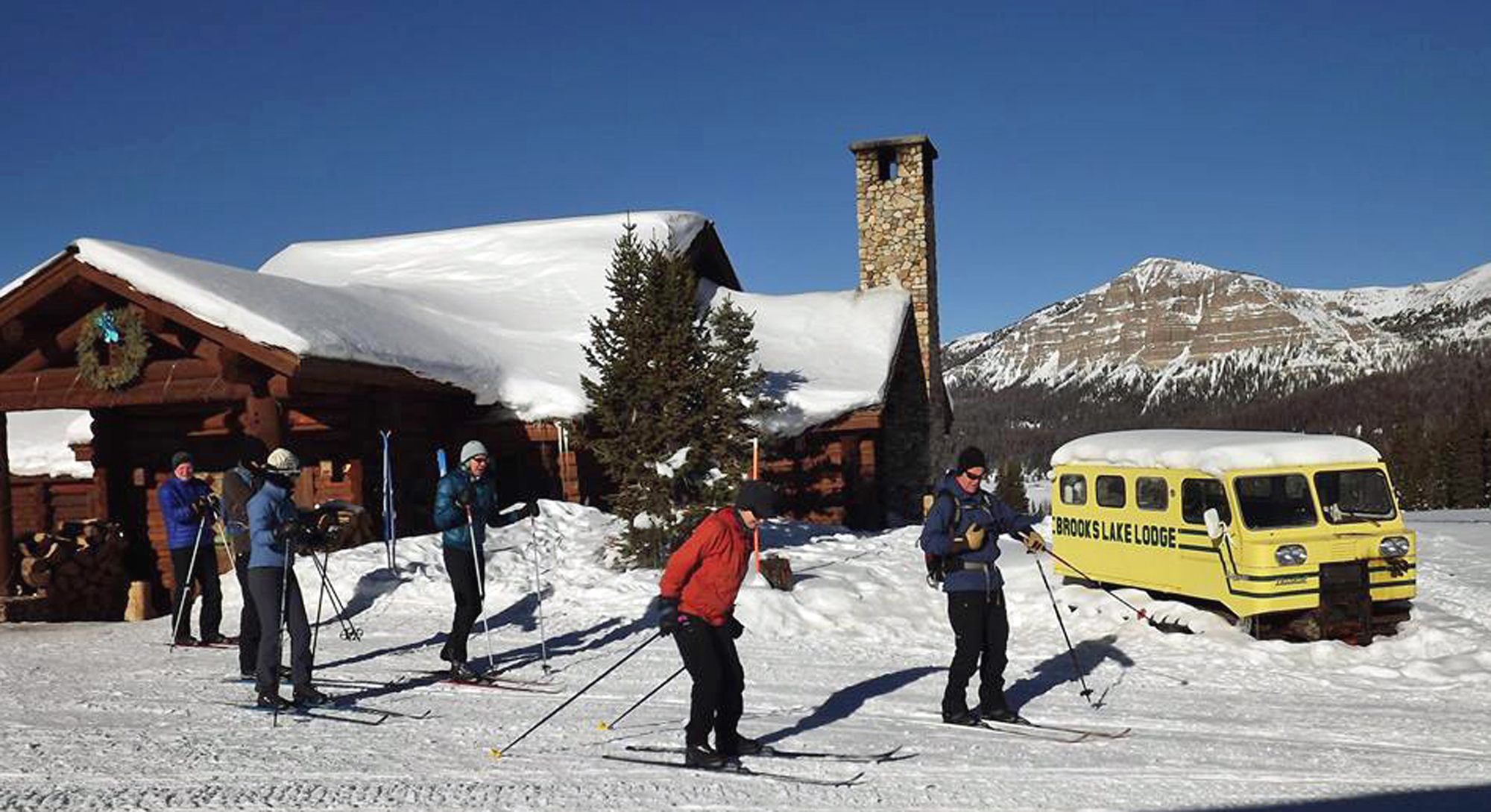 Couples can enjoy outdoor adventures with cross-country skiing, snowmobiling, ice fishing and more throughout the winter at Brooks Lake Lodge, exploring the vast snowy terrain.