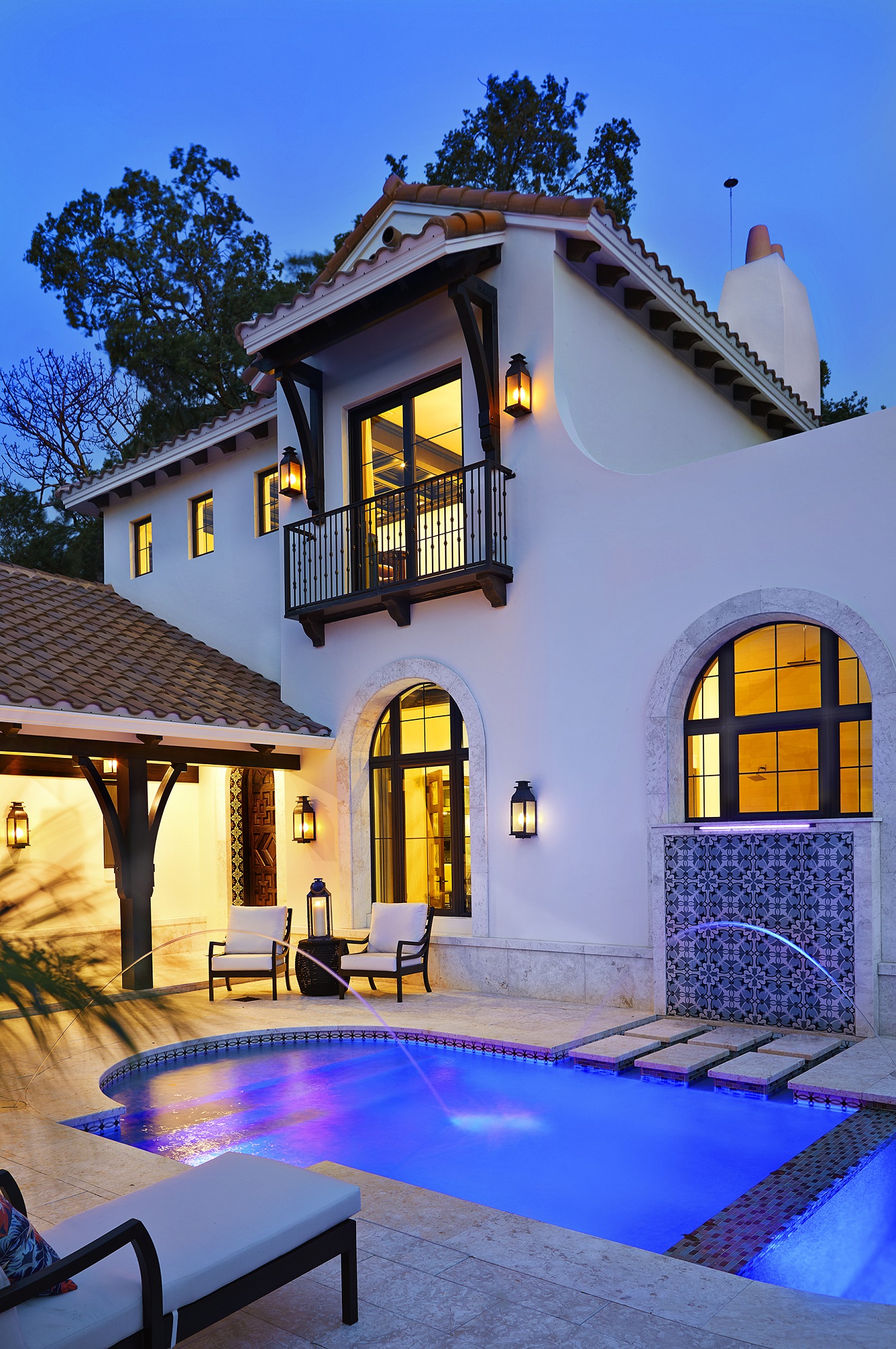 A contemporary courtyard interpretation of the required Spanish Mission architectural style wraps the lush colors, senses and textures of the surroundings into the home’s exterior and interior design.