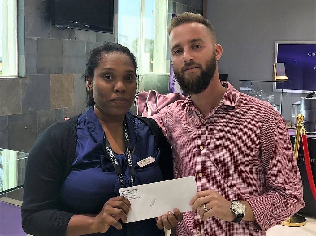 Employee in Grand Turk receives Diamonds International's relief funding from the General Manager