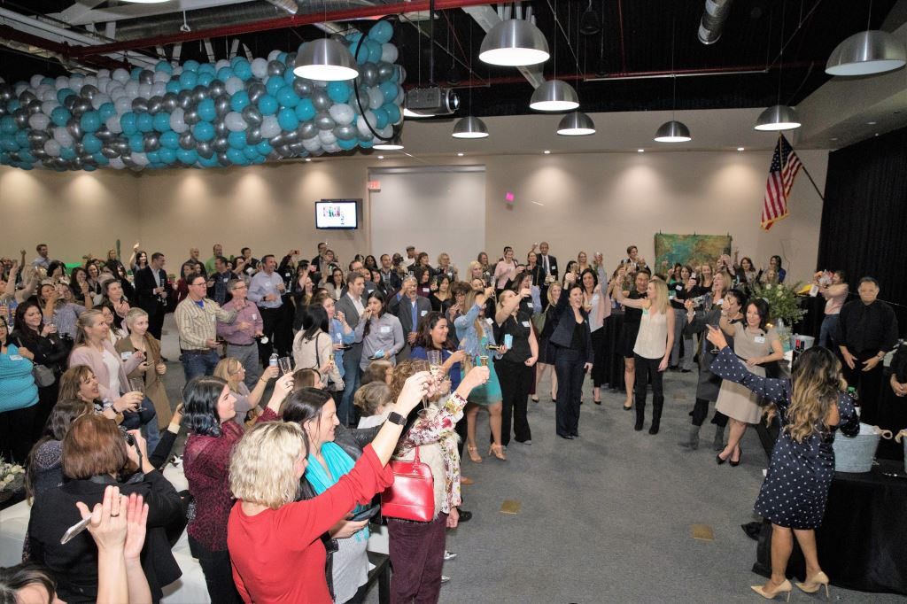 WiOPS members toast five years at their anniversary celebration in January 2018.