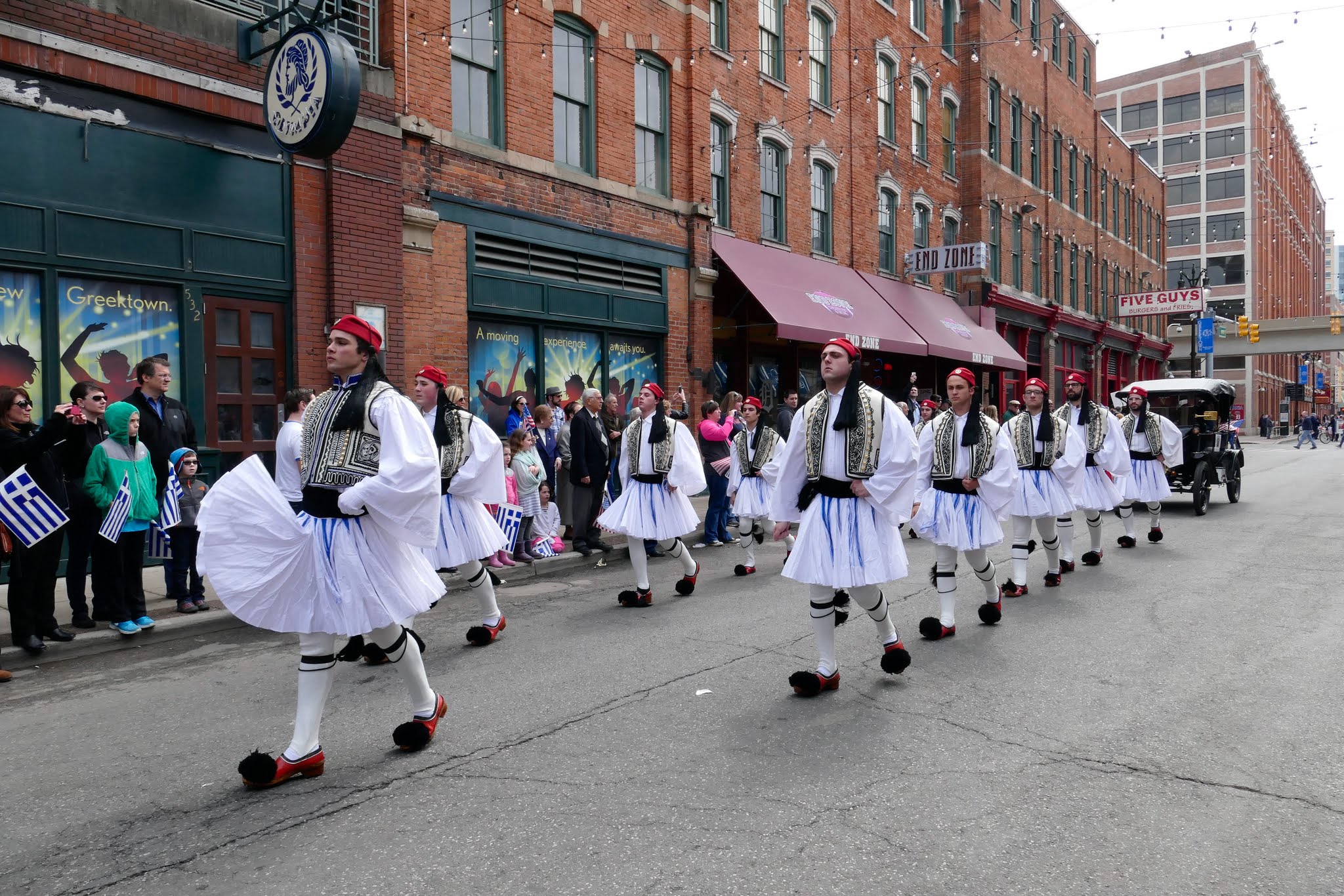 Evzones, a ceremonial Greek guard unit, march down Monroe Street during the annual Detroit Greek Independence Day Parade.