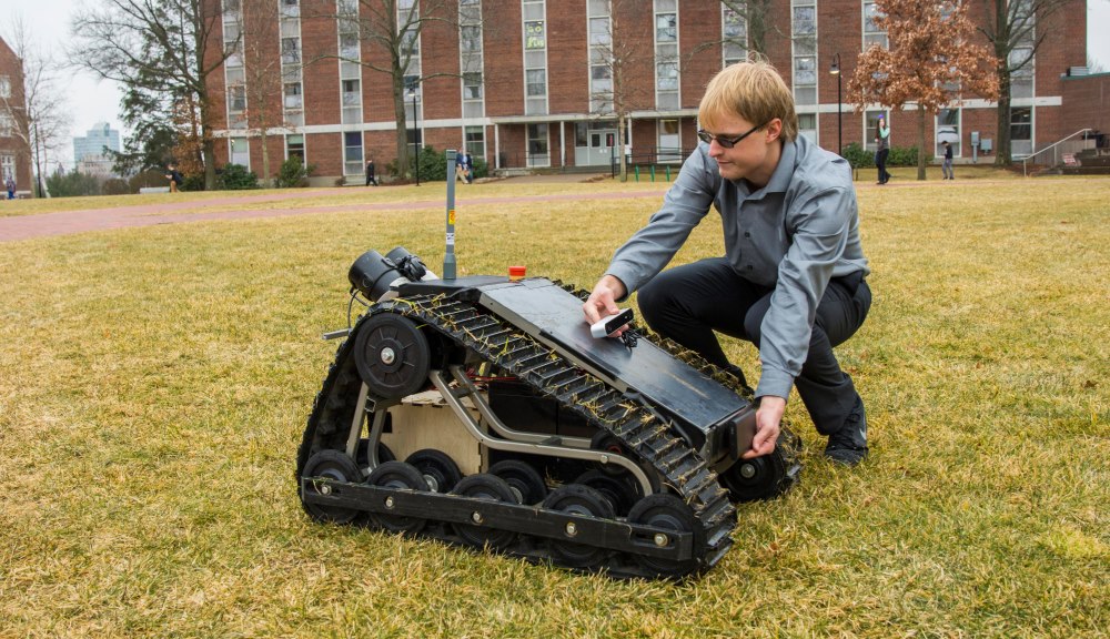 Jeff Tolbert indicates where sensors and cameras will be installed on the robot to allow it to navigate