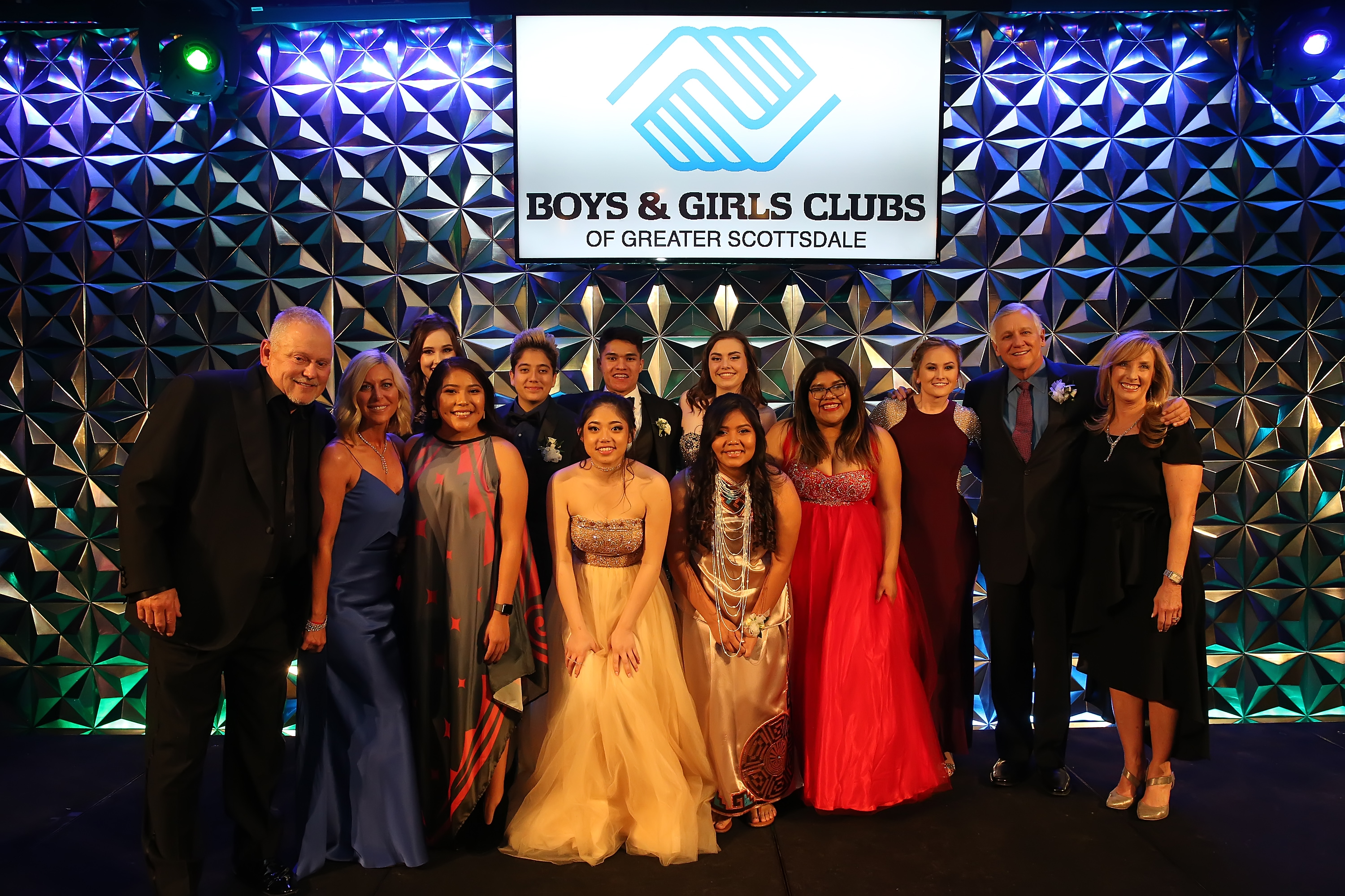 Bob & Renee Parsons join Boys & Girls Clubs of Greater Scottsdale Youth of the Year finalists on stage following scholarship award announcement.