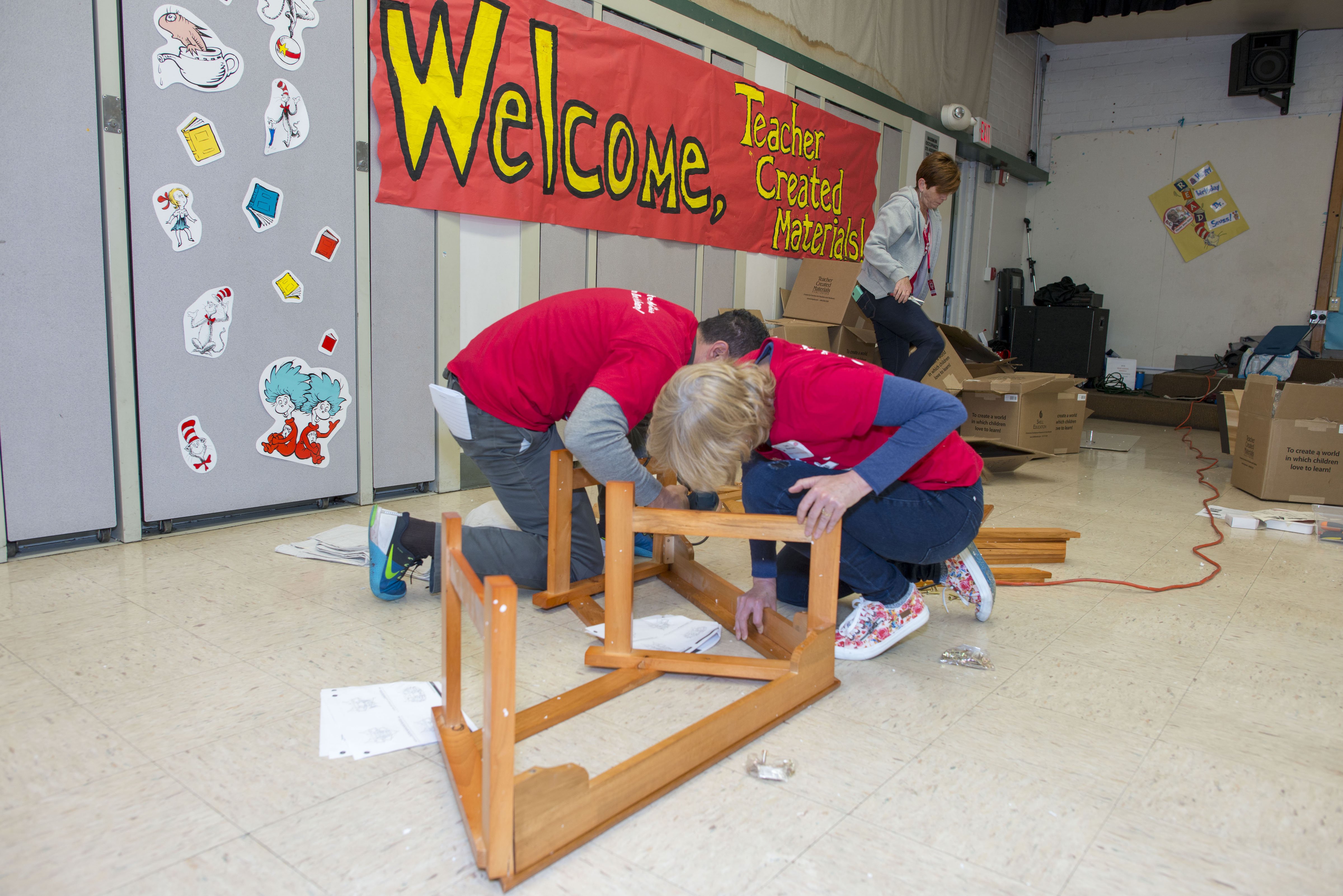 Teacher Created Materials staff build a reading bench for the playground at Carl E. Gilbert Elementary School