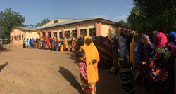 Caretakers in Zambia waiting to get their infants immunized and receive case transfers.