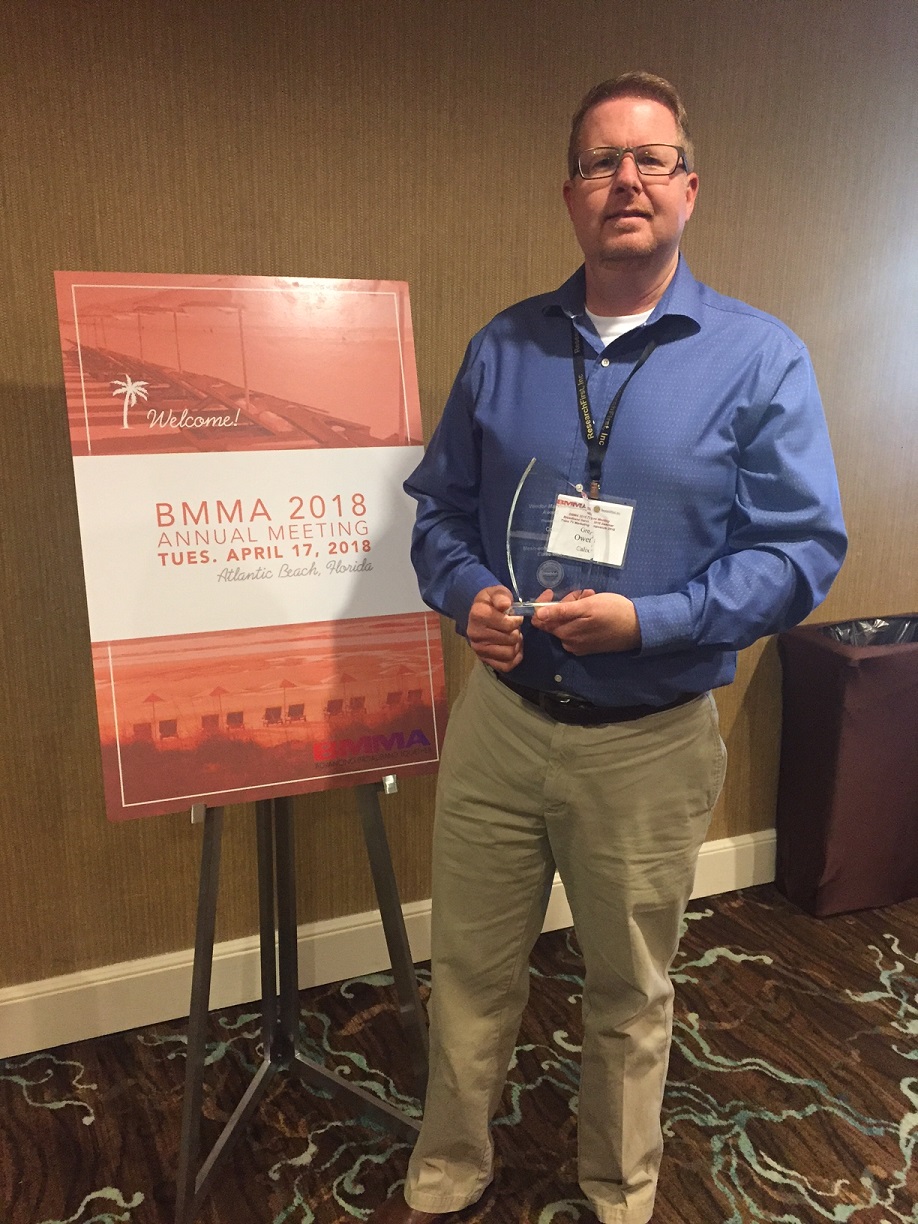 Greg Owens of Calix accepts the BMMA Best in Class Vendor Marketing Award at the 2018 BMMA Annual Meeting in Atlantic Beach, FL.