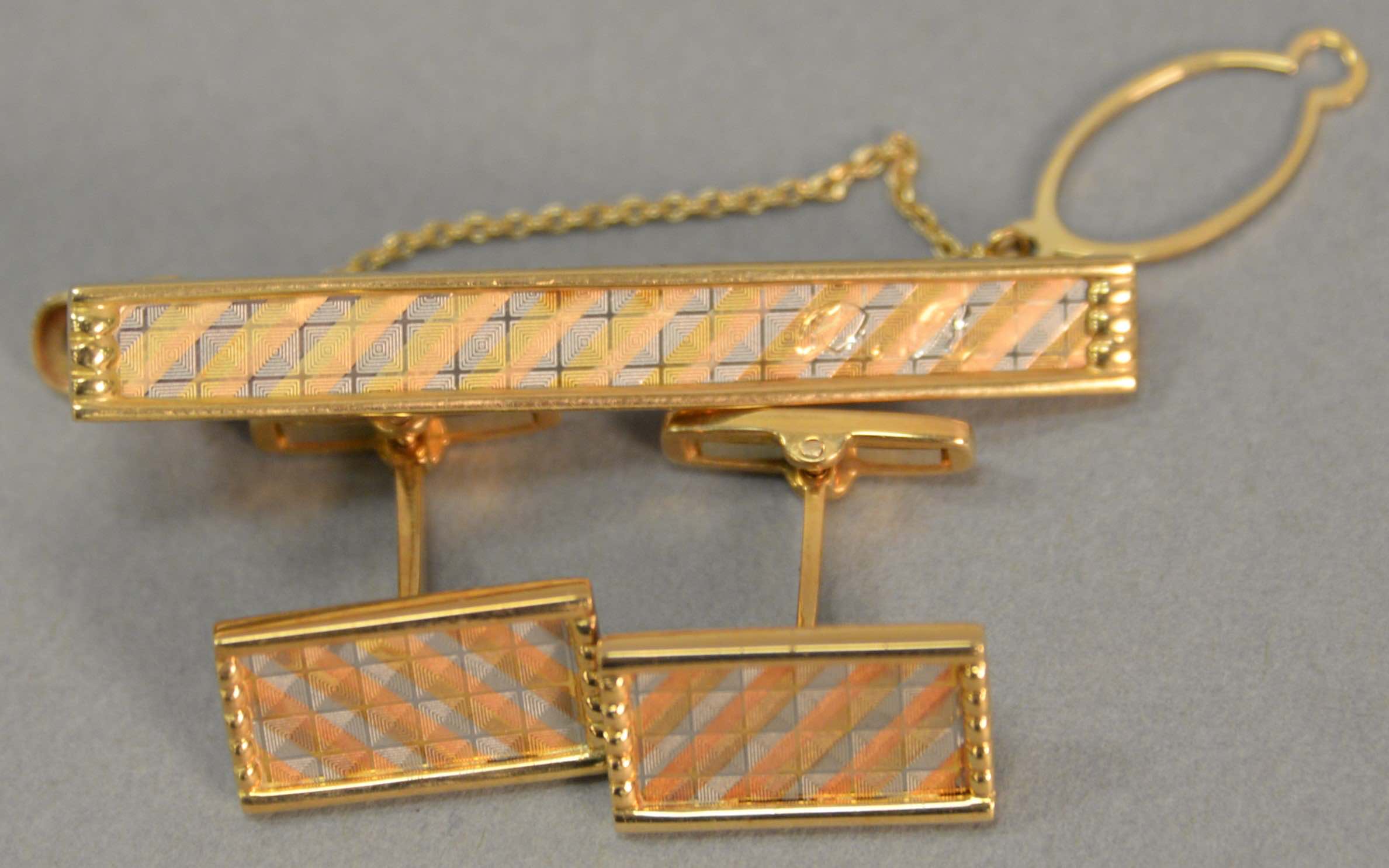 DR monogrammed Mitsubishi 18k cufflinks and tie clip set, estimated at $400-600.