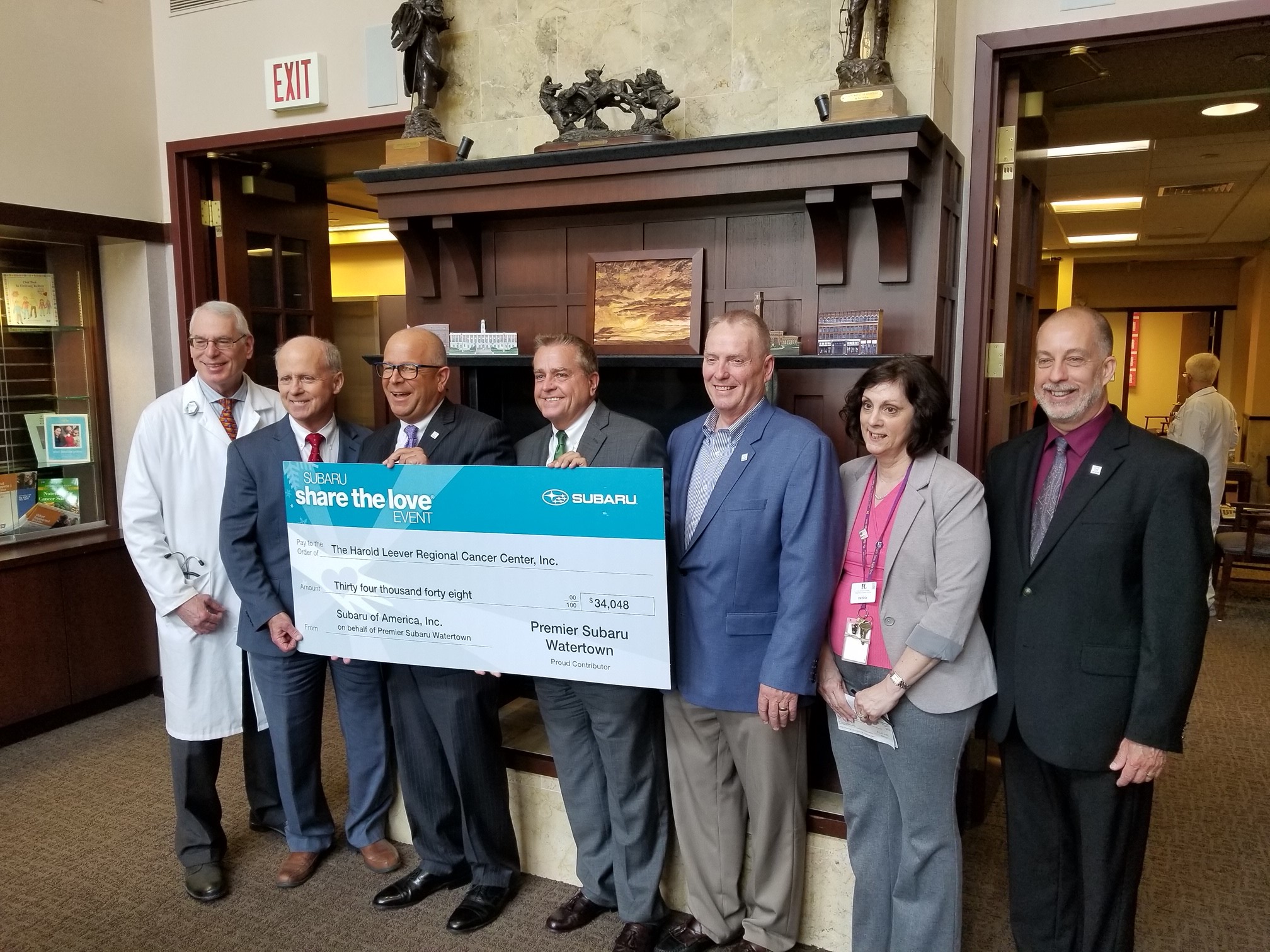 Robert J. Alvine presents the team from the Harold Leever Regional Cancer Center a Check