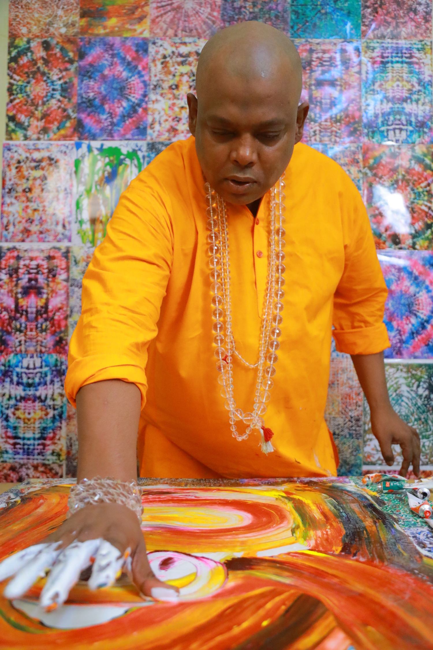 Parijoy Saha making a painting with bare hands.