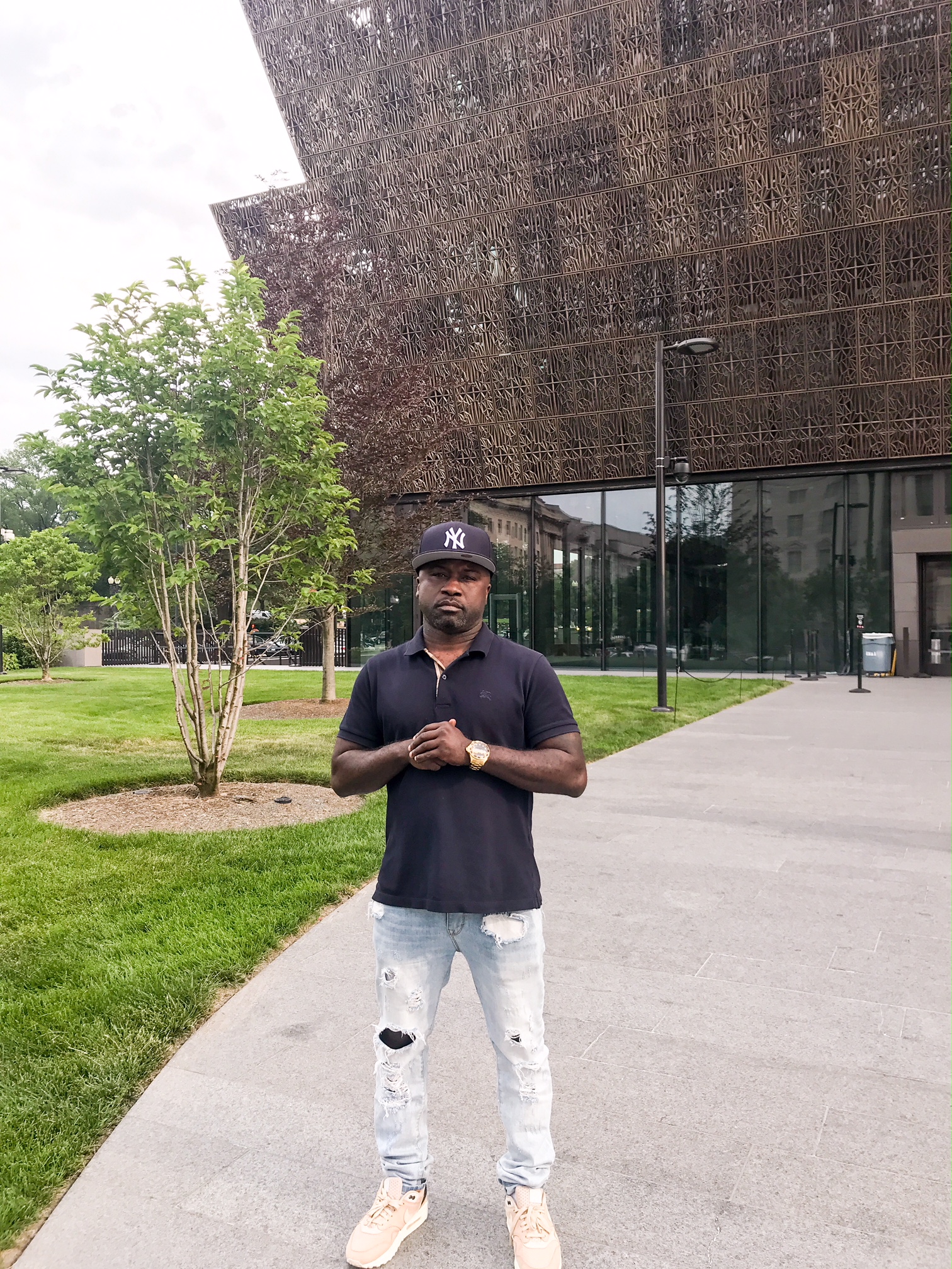 Havoc standing in front of the National Museum of African American History and Culture