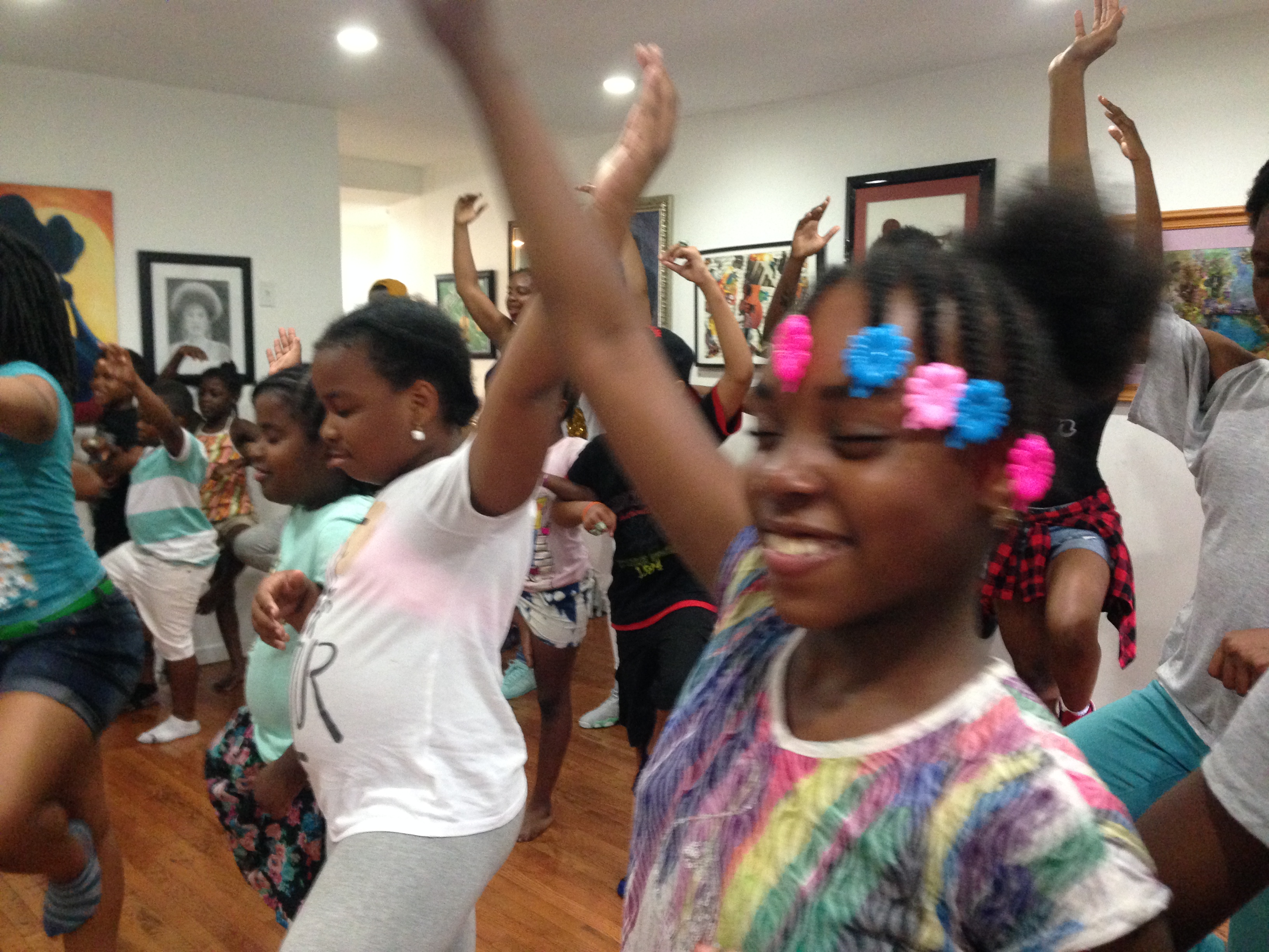 Young ladies demonstrate a “tree pose” (yoga position) with their eyes closed, during Bailey’s Café’s six-week free arts-based rites of passage summer program for young people ages 9 to 19.