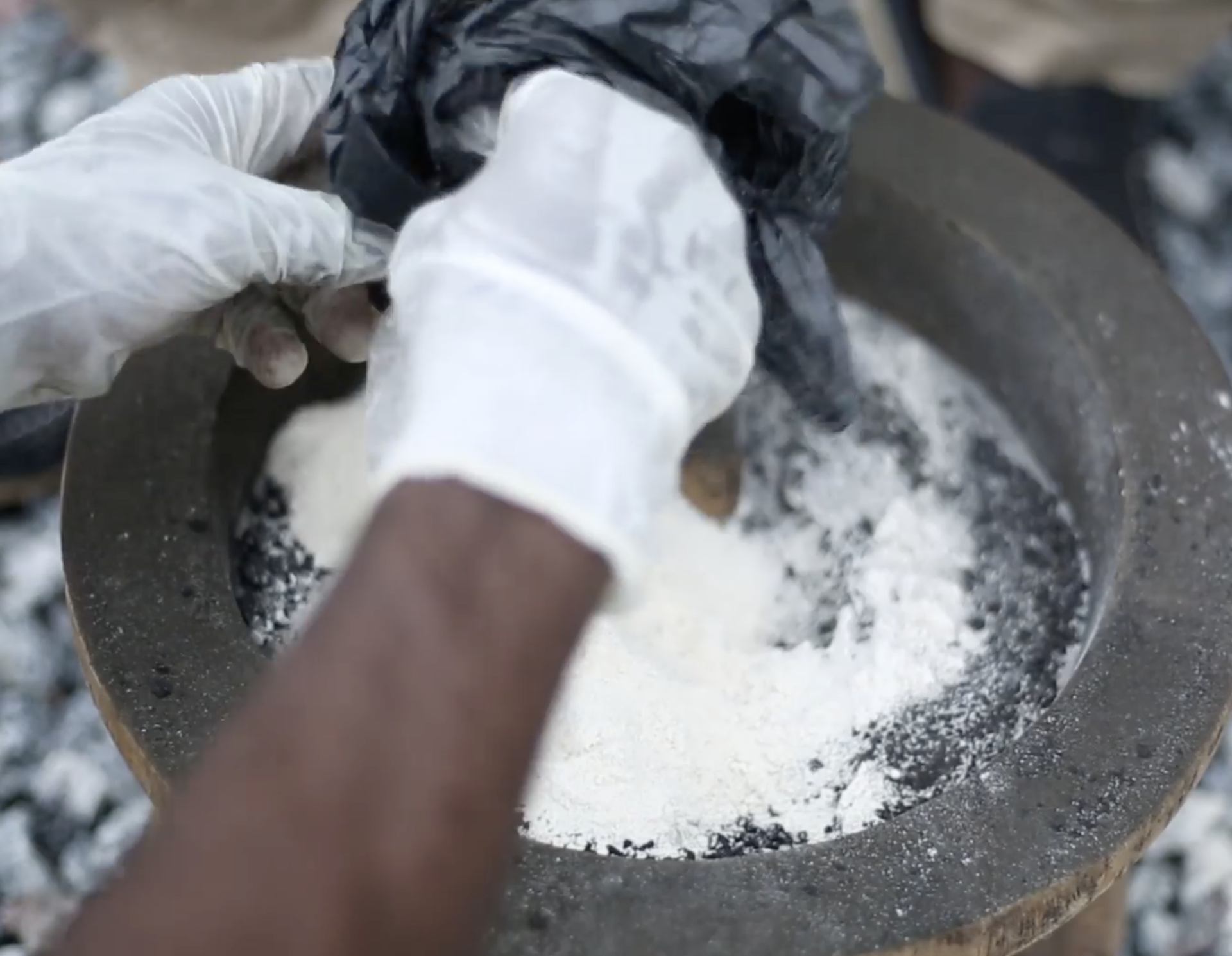 Cassava flour - an organic commodity in West Africa that is plentiful and relatively inexpensive - is added to a mixture of human waste and polymer to help create a charcoal product.