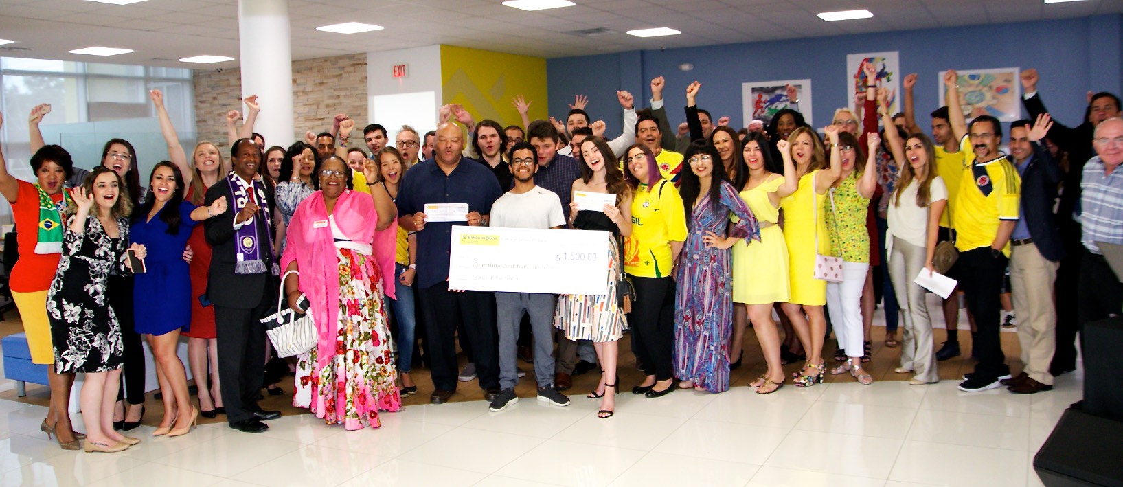 A jubilant crowd cheers on the winners and their favorite teams during the opening of the “Passion for Soccer” Art Exhibition at Banco Do Brasil America on Idrive ((Photo by Greg Griffin)