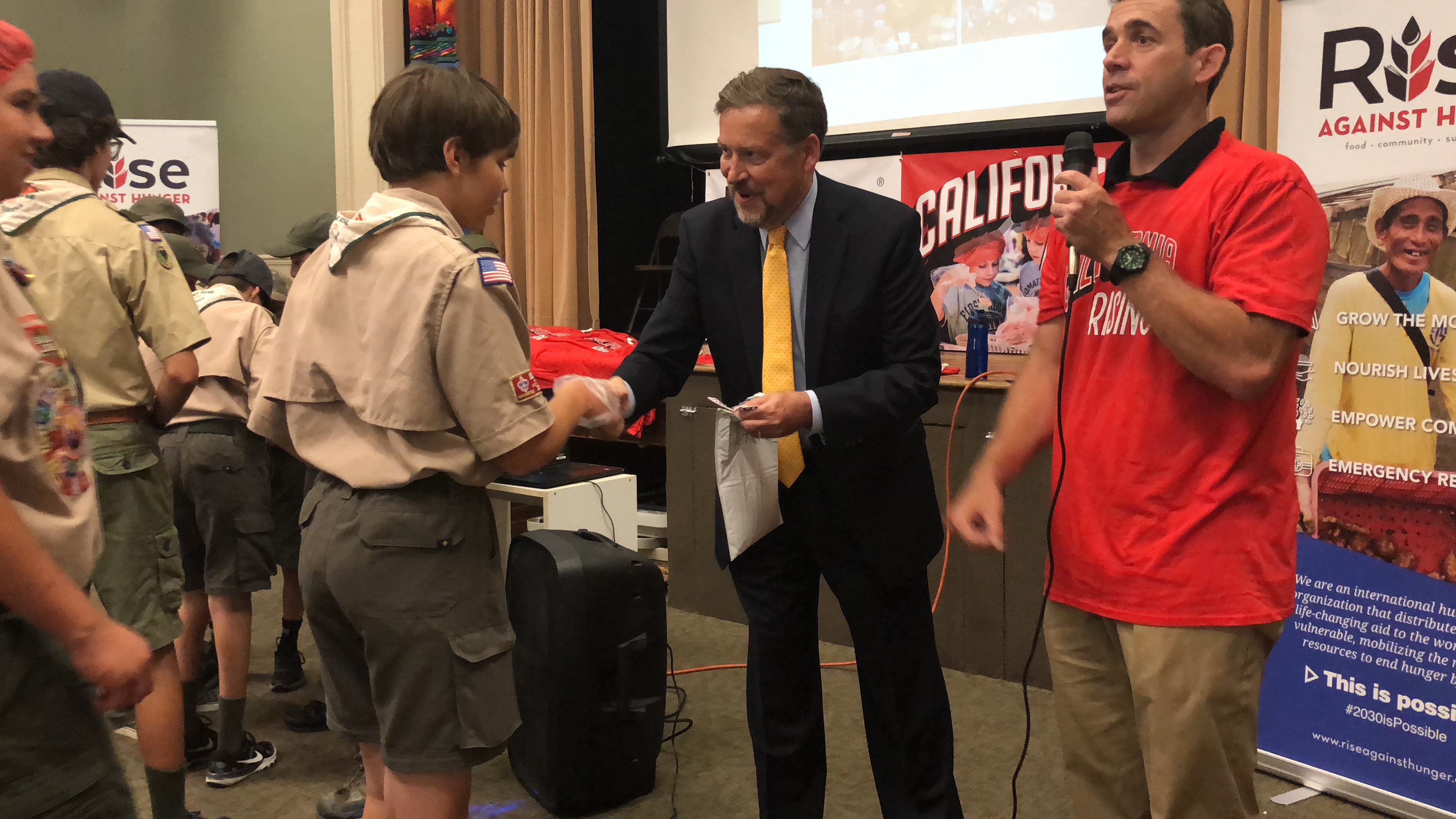 Tom Pyke, CA-17, hands out service badges to scouts.