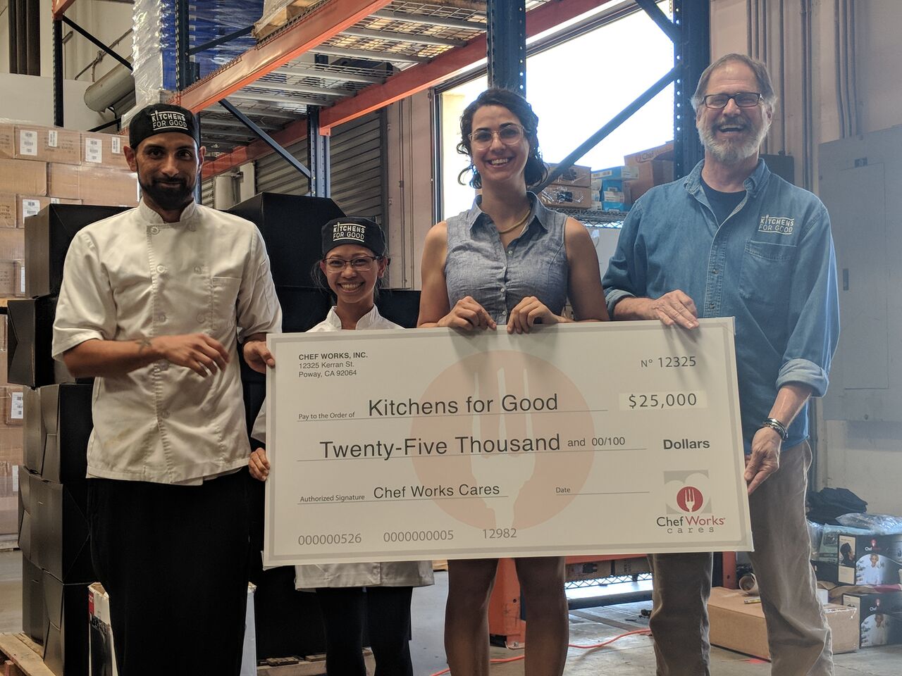 Members of Kitchens for Good accepted their $25,000 check at the Chef Works distribution center in San Diego.