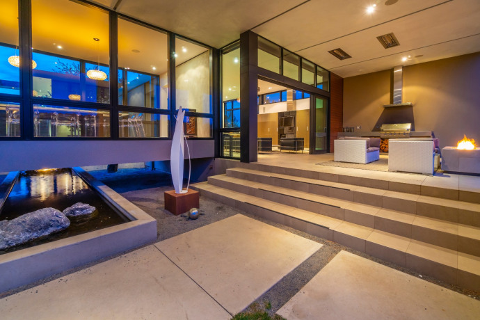 Luxury home with a creek-like water feature runs through the front entry, courtyard and under the dining room to the backyard