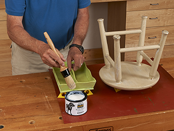 Harpool uses a Black Dog Salvage Round Brush #10 to apply the new Black Dog Salvage Show Dog Furniture Paint Topcoat to a tray painted with Black Dog Salvage Patinio Greenio Furniture Paint.