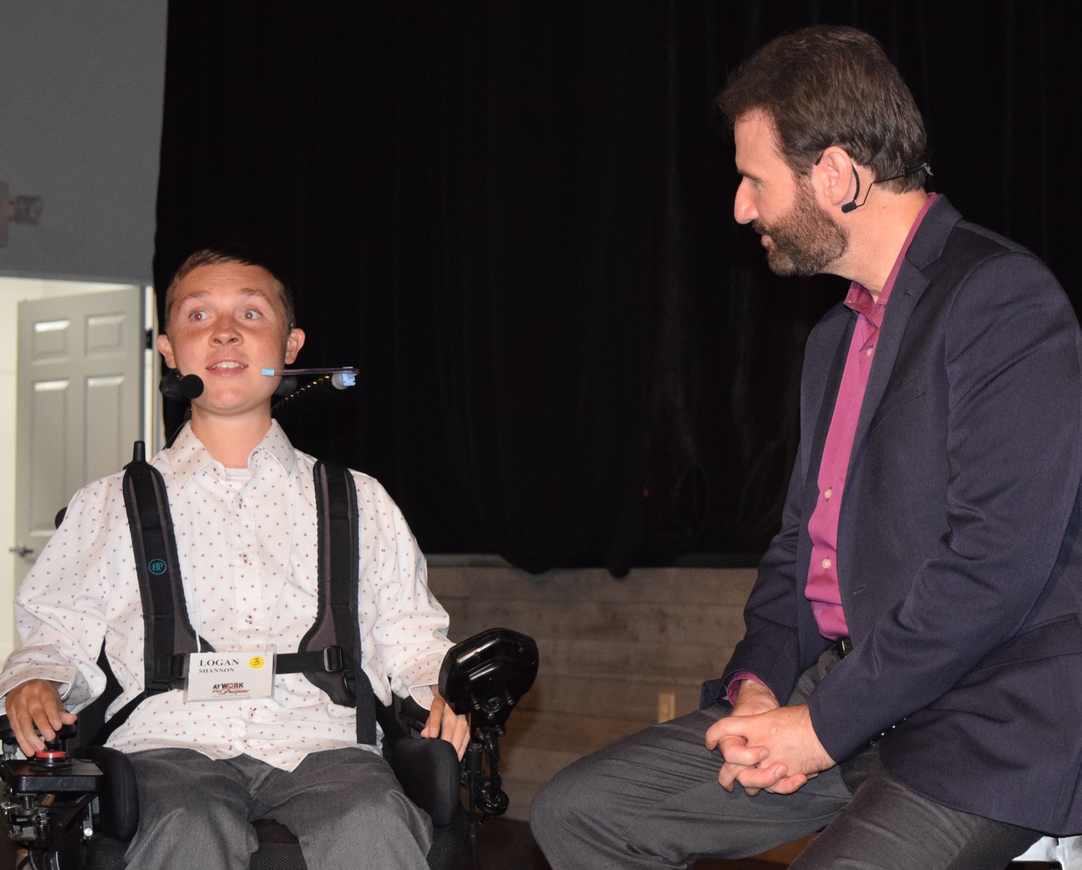 Logan Shannon speaks about God’s role in his life with AWOP founder Chuck Proudfit at the XL Summit. (Oak Tree Communications Photo)