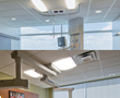 Patient room medical equipment often shares ceiling space with light fixtures.
