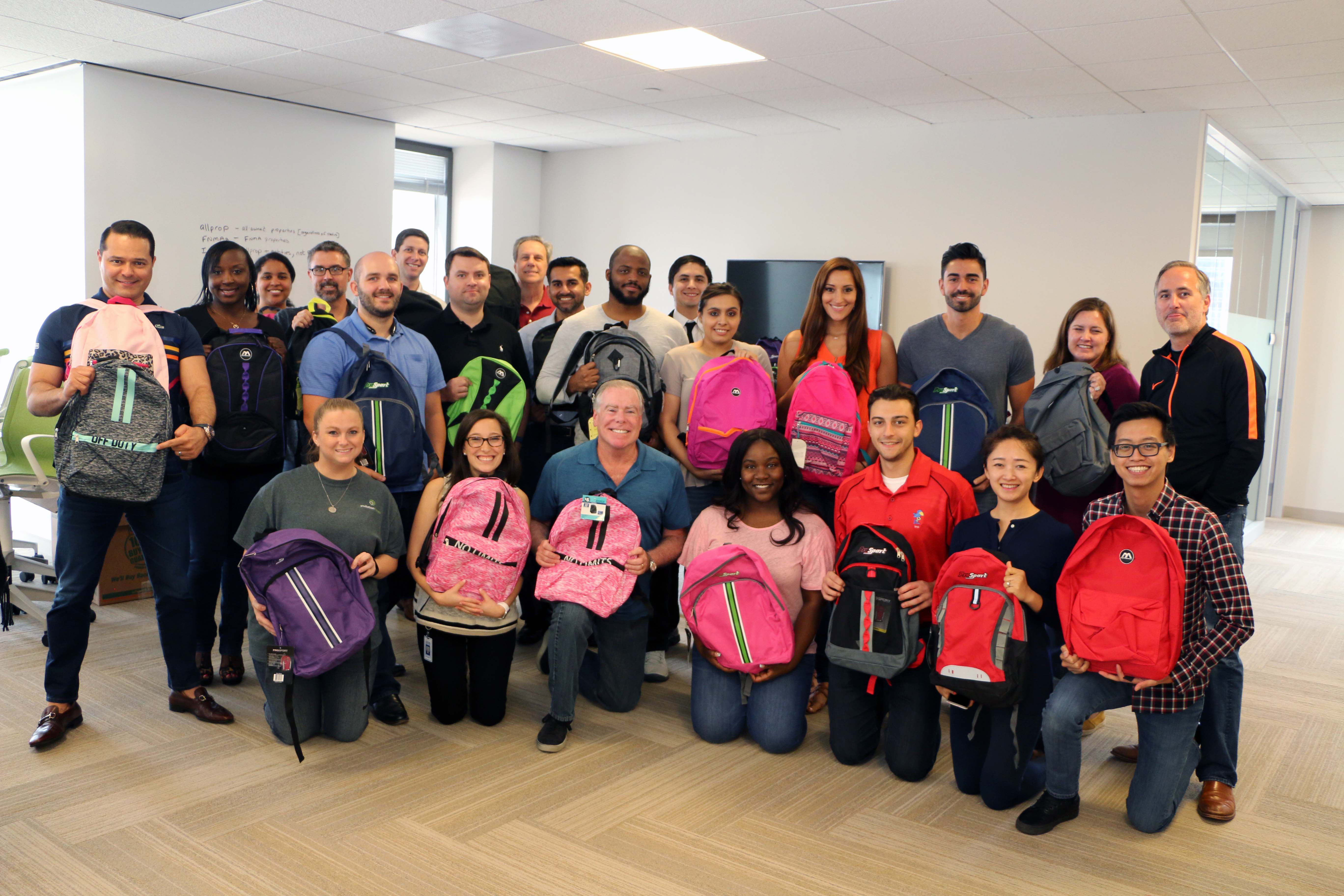 Invitation Homes associates donate backpacks to local communities.