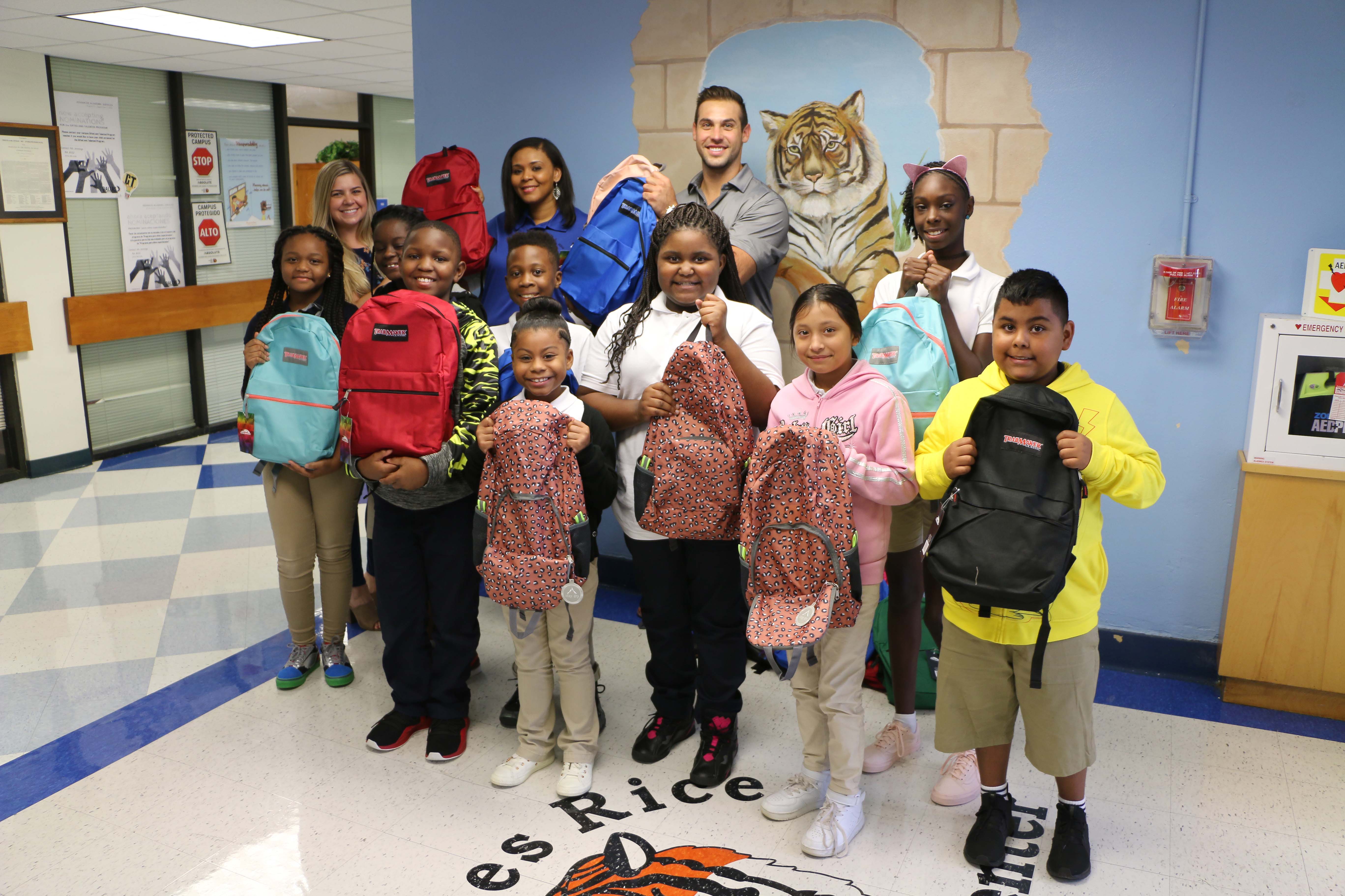 Invitation Homes associates deliver backpacks to the Charles Rice Learning Center.