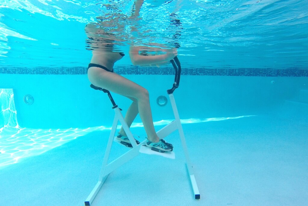 A women Aquabiking on her Fitness model (https://wike-up.com/)