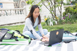 Teen girl outside with laptop