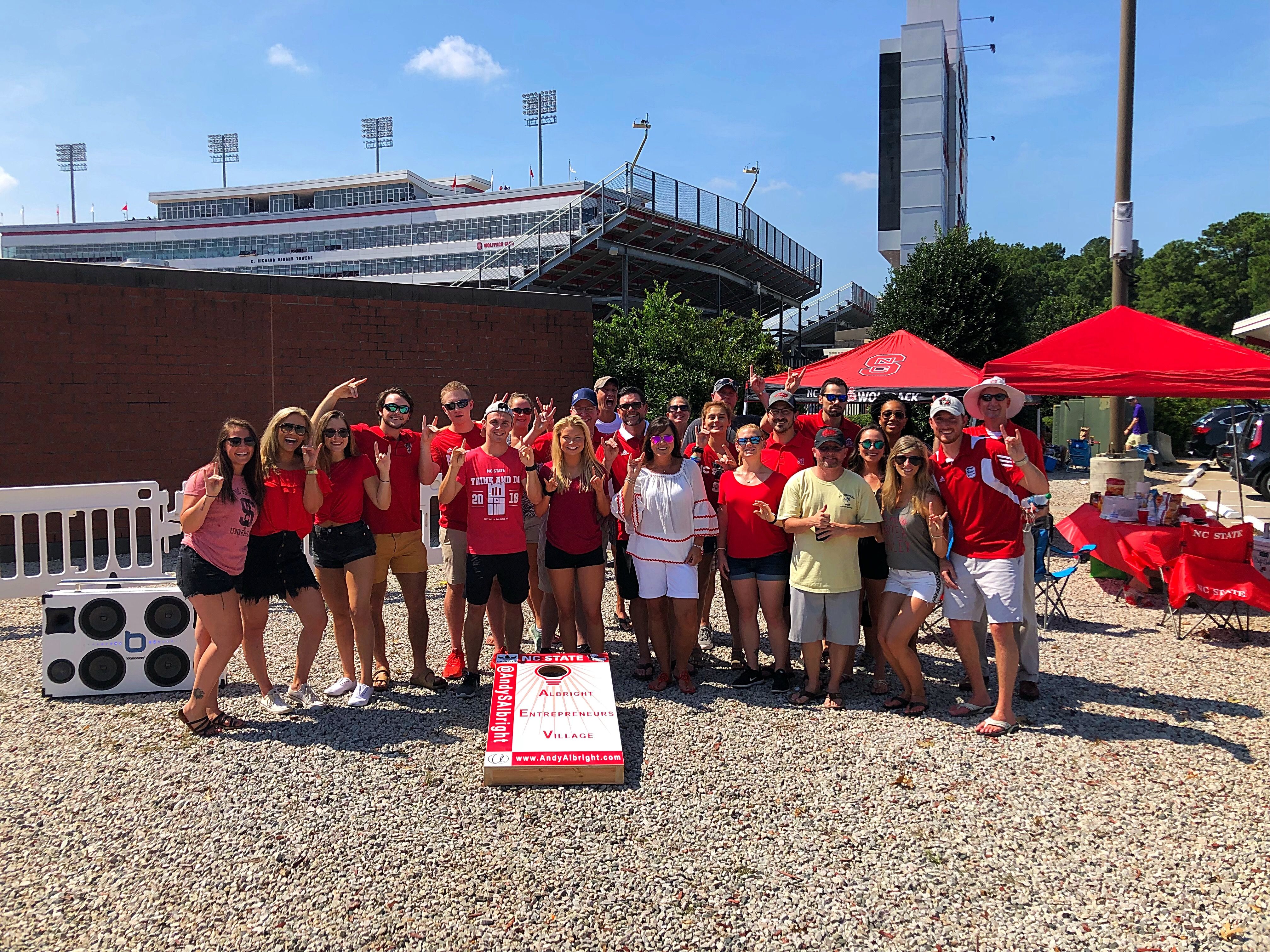 Members of The Alliance pose for a photo before heading to the NC State football game to witness the official kickoff coin toss sponsored by The Alliance at NC State home games this season.