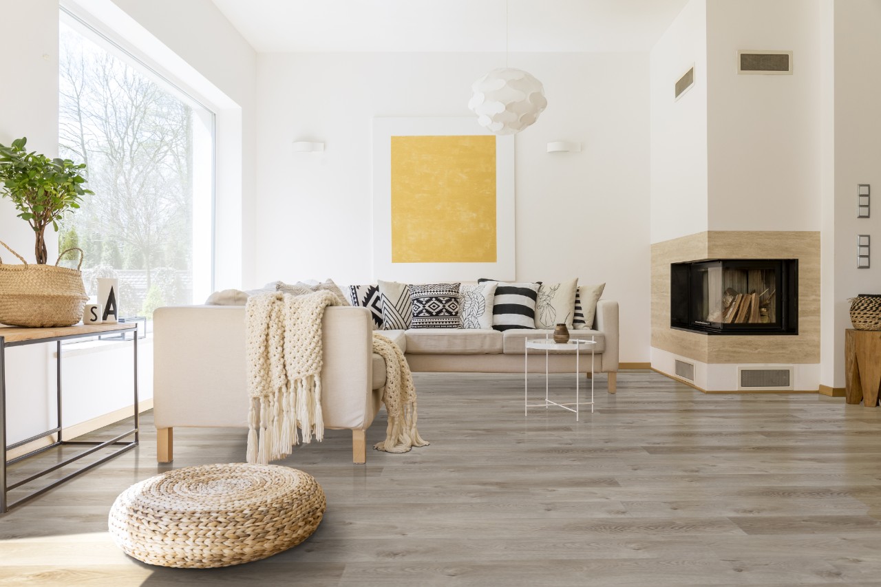 This bright living room showcases the rigid core Prescott series in the color Whitfield Gray.
